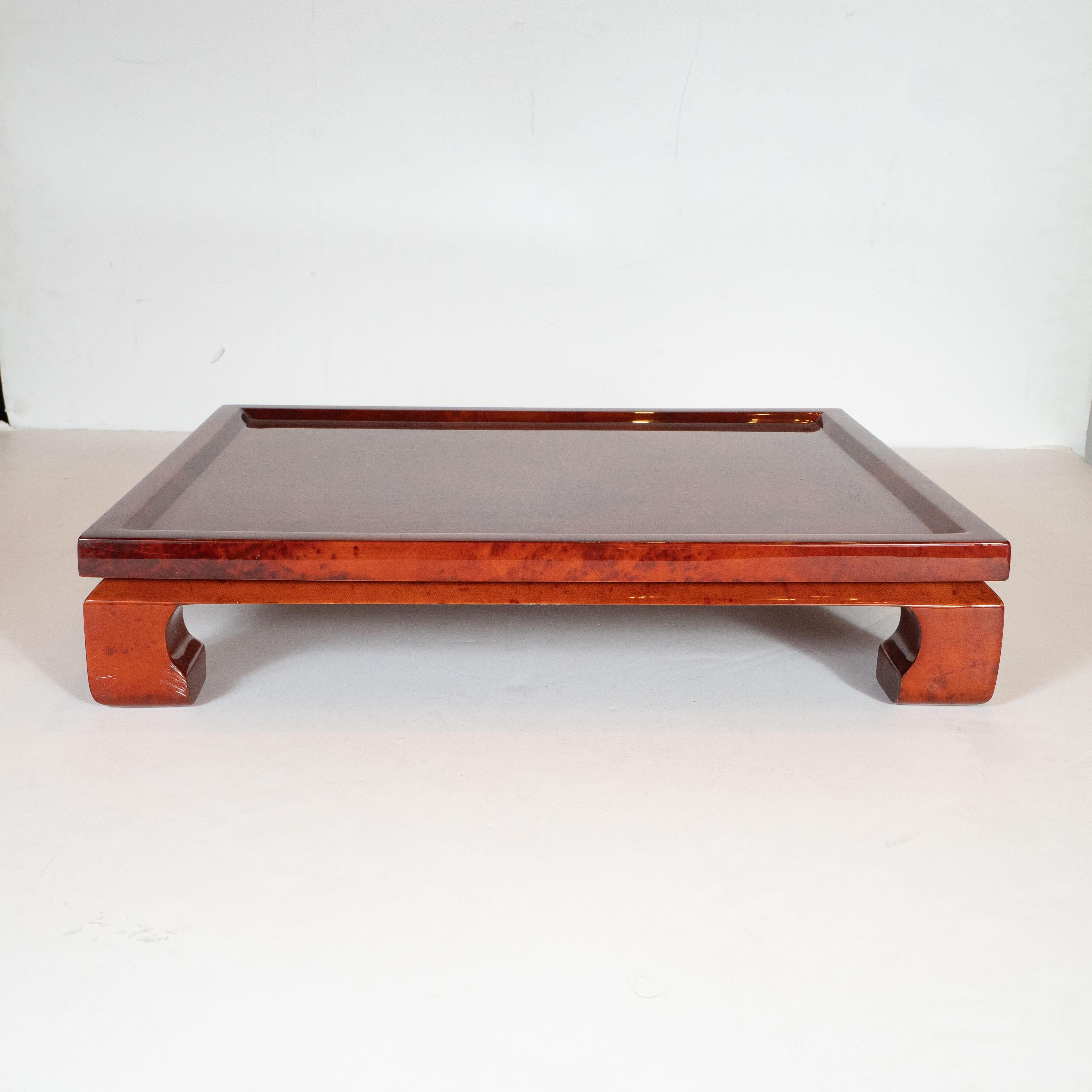 This beautiful Mid-Century Modern bar tray was handmade in Colombia, circa 1980. It features a pagoda form with stylized chinoiserie style legs; a volumetric rectangular body and a beveled apron- all realized in lacquered goatskin of a rich chestnut
