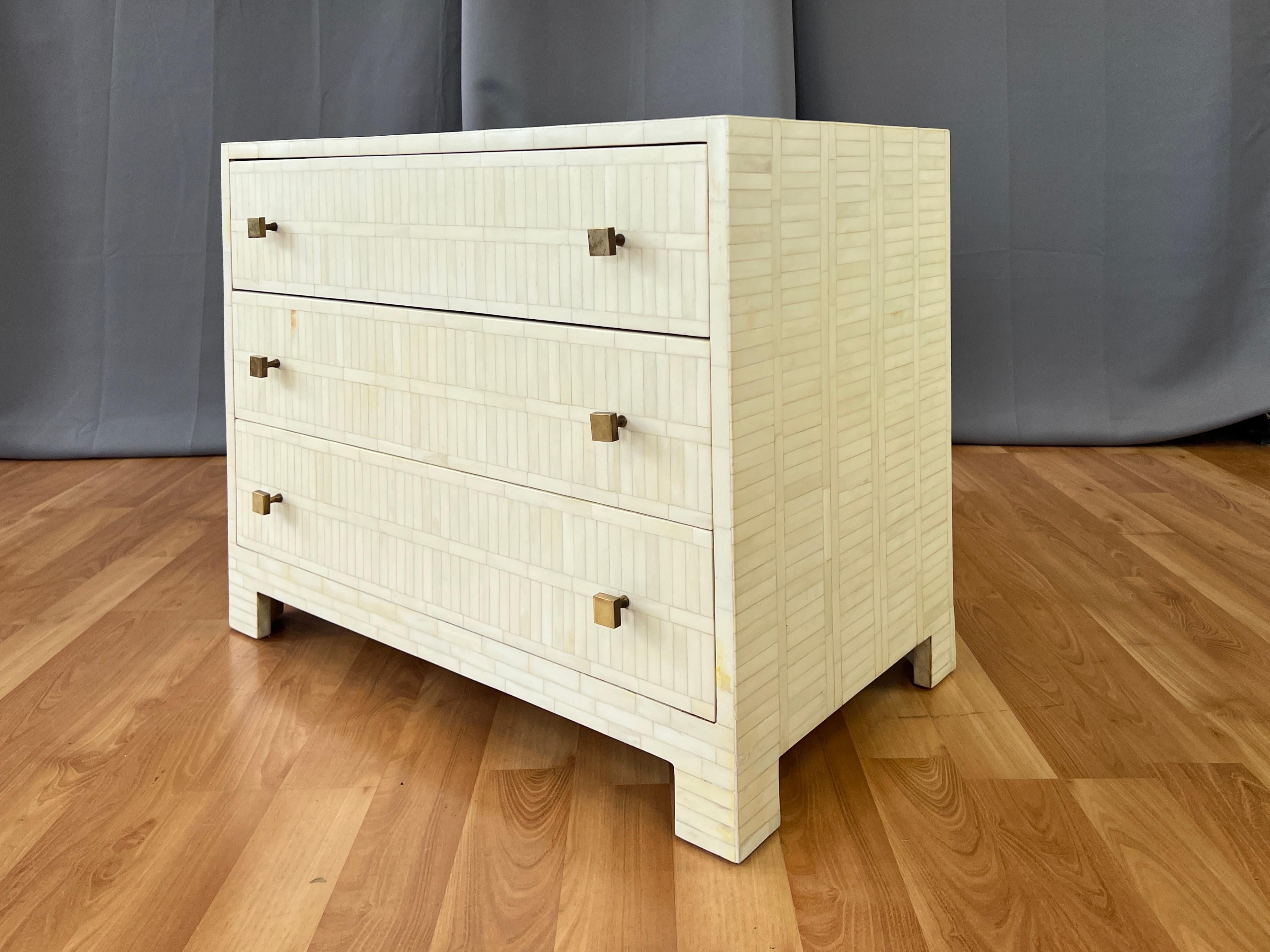A super chic circa 1980 tessellated bone three-drawer dresser in the style of Enrique Garcel or Jimeco Itda.

Clean lines and perfect proportions, all clad head-to-toe in more than one thousand meticulously cut and placed off-white bone tiles.