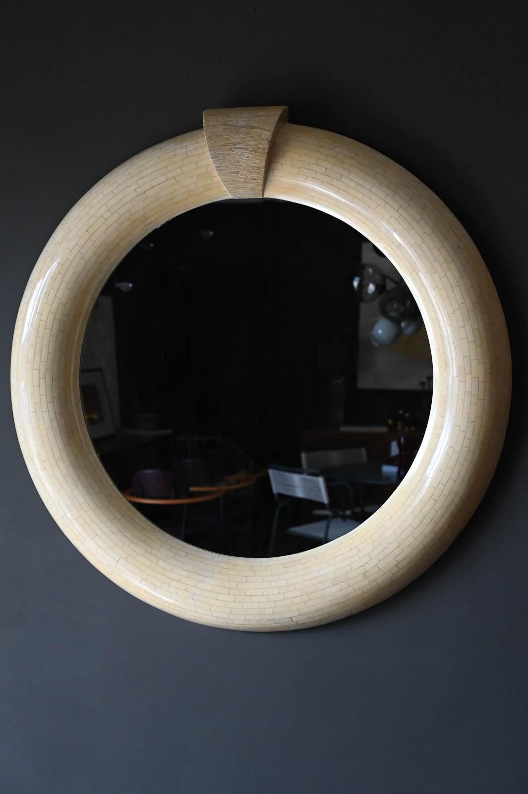 Enrique Garcel round tessellated bone mirror, circa. 1970. Beautiful tessellated bone with crown detail. Mirror is free of cracks or chips and frame is in excellent vintage condition. Signed on reverse.

Measures 48