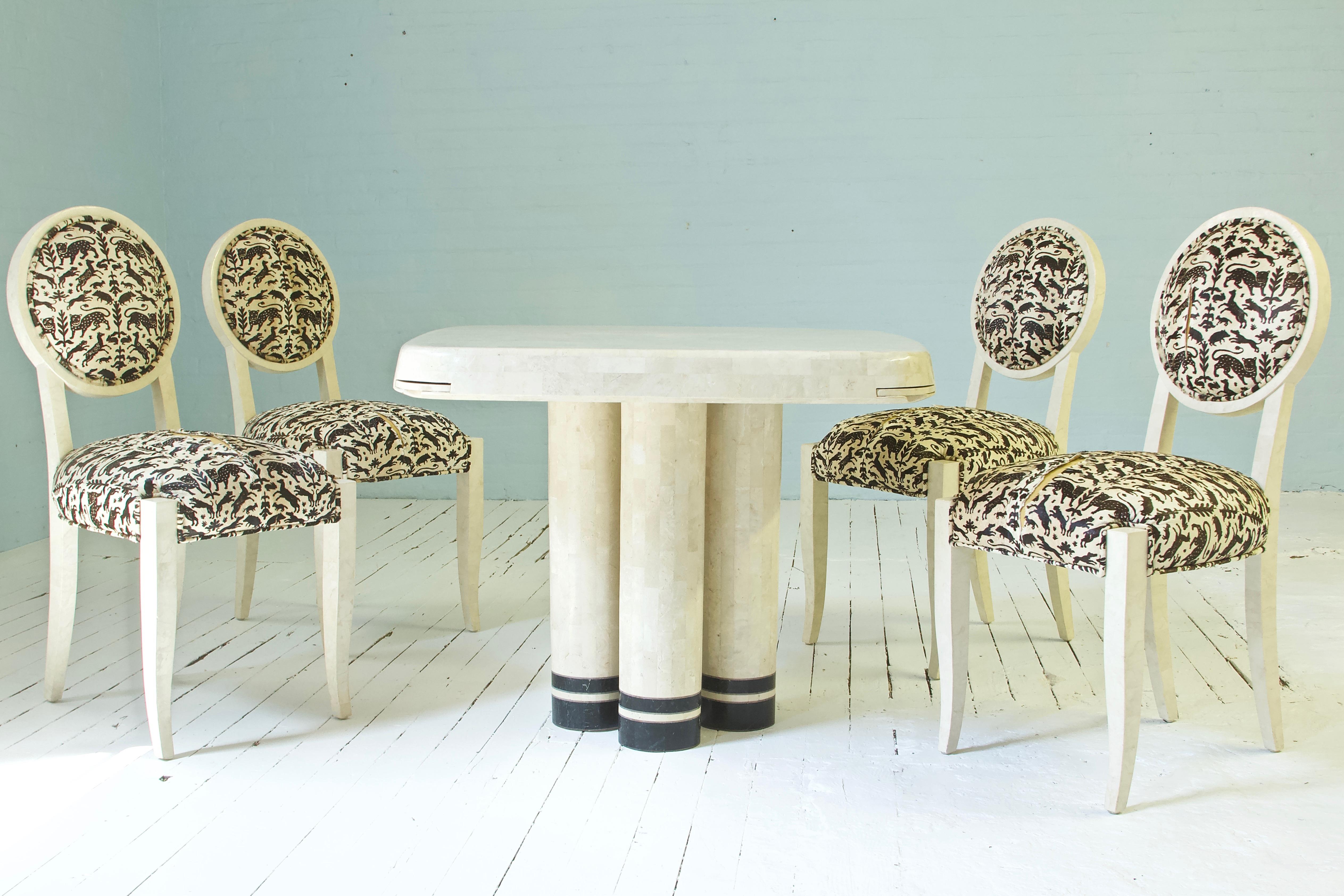 Great statement set comprised of four balloon back chairs and one table with pedestal base and four retractable cup holders. The table can function as a game table, a cocktail table, or just a sophisticated setting for intimate dining. The condition