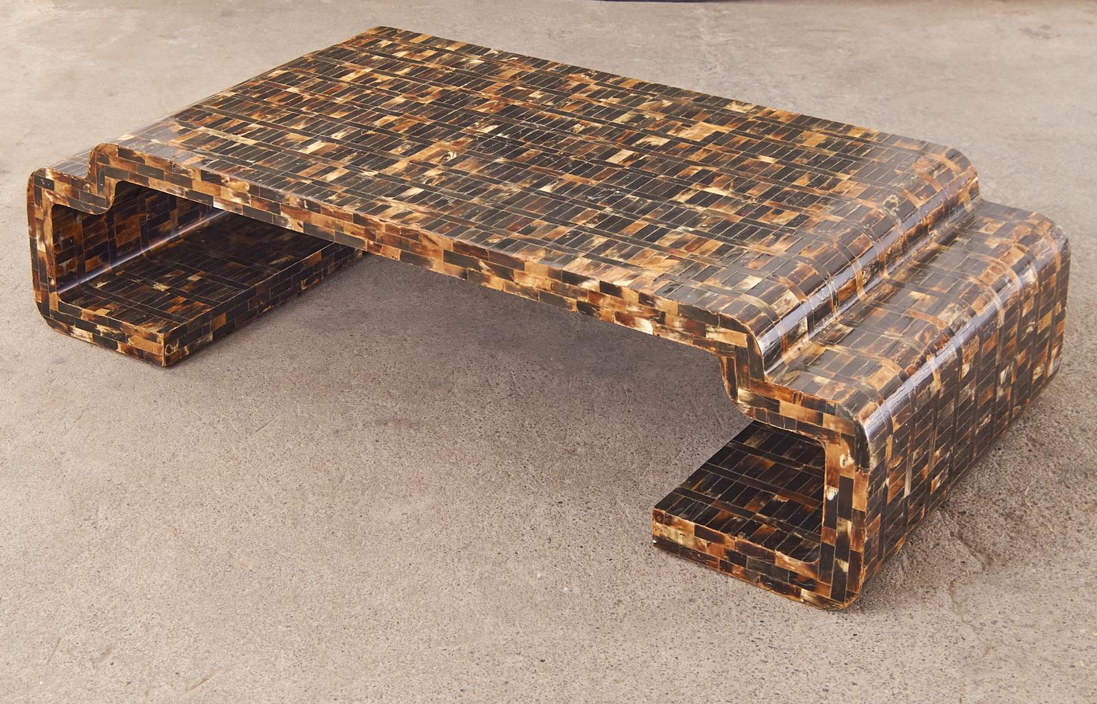 Extraordinary faux-tortoise shell tessellated horn veneer coffee or cocktail table attributed to Enrique Garcel. Made in Colombia the table has a 2.5 inch thick wood frame with stepped ends in a greek key motif. The surfaces are veneered with horn