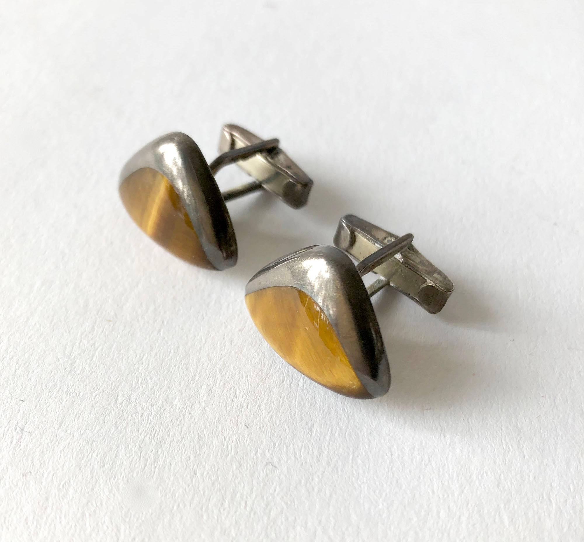 Darkened sterling silver and tiger's eye modernist cufflinks created by Enrique Ledesma of Taxco, Mexico. Cufflinks measure 7/8