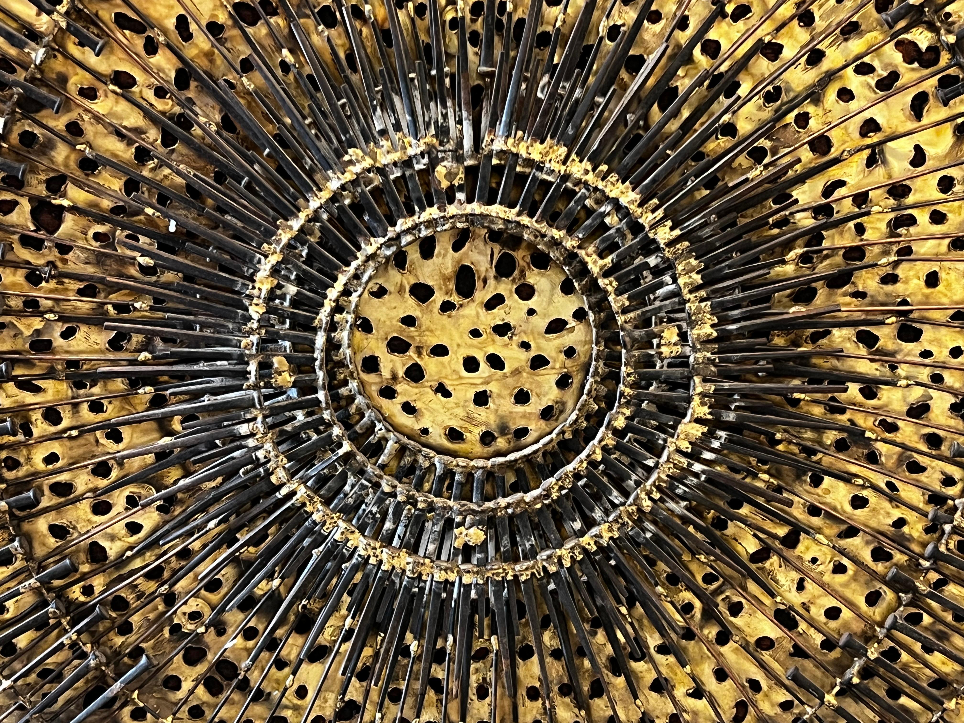 Stunning Mid Century Brutalist Mixed Metal Sunburst Wall Sculpture signed Enrique Parker.  Overall excellent condition with age appropriate wear.  Possible that some nails have come loose with time.  

Measures approximately 39.5
