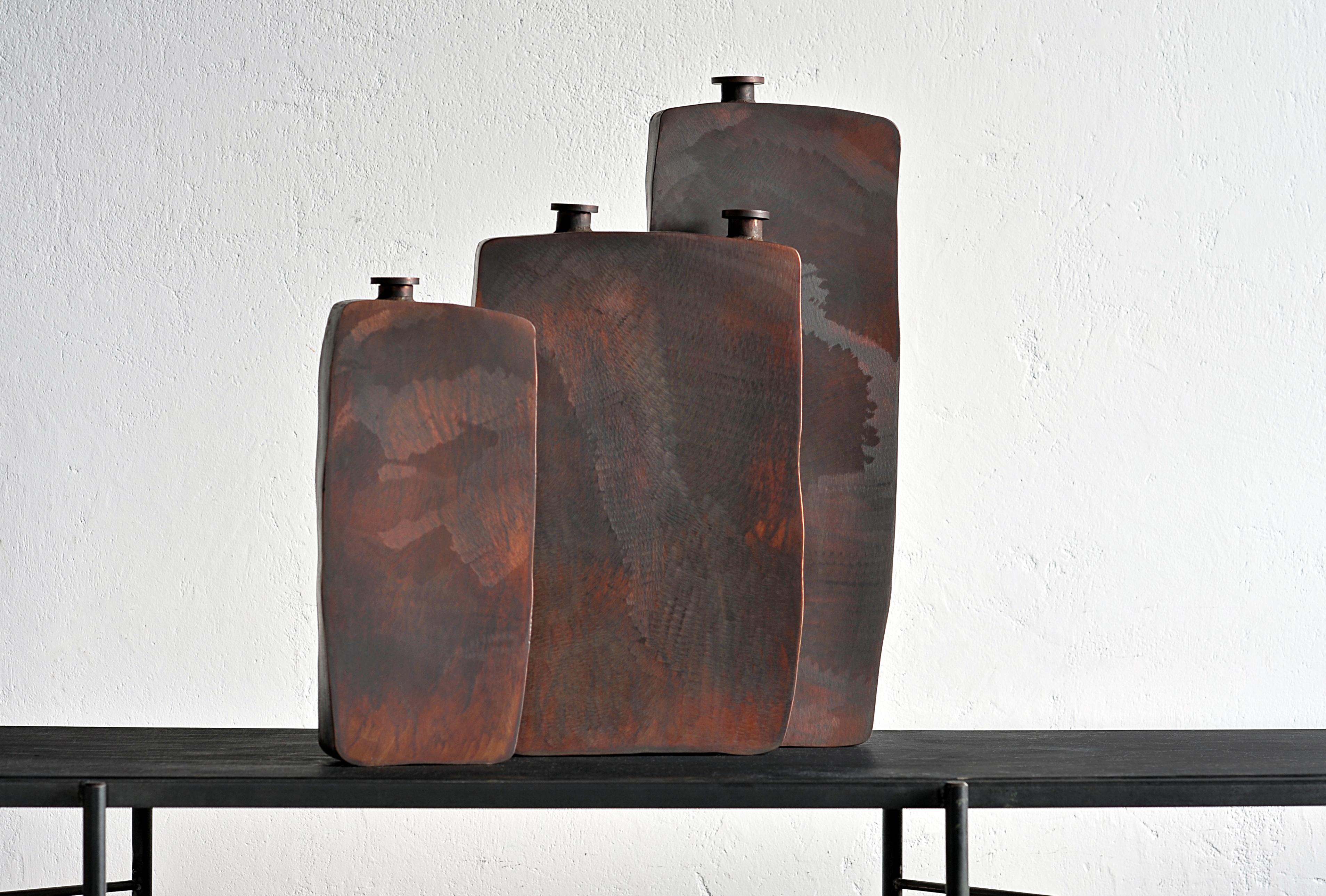 Ensemble of three brown bottles by Lukasz Friedrich
Dimensions: Small bottle 15 x 5 x H 34 cm
Medium bottle 24 x 5.5 x H 40 cm
Large bottle 19.5 x 4.5 x H 50 cm
Materials: Patinated steel.