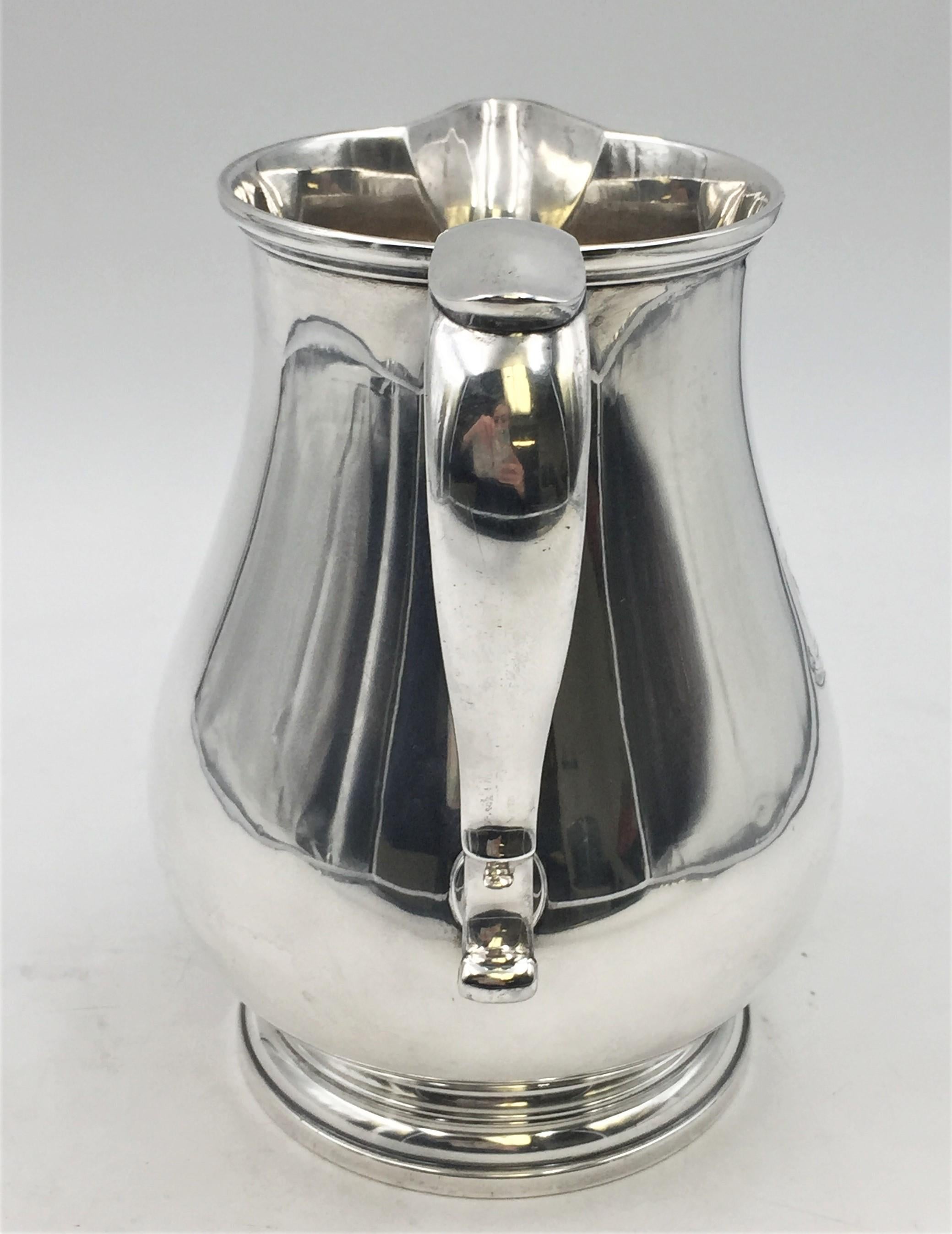 Ensko, American, early 20th century sterling silver spouted water pitcher in Georgian style with engraved birds and motto 