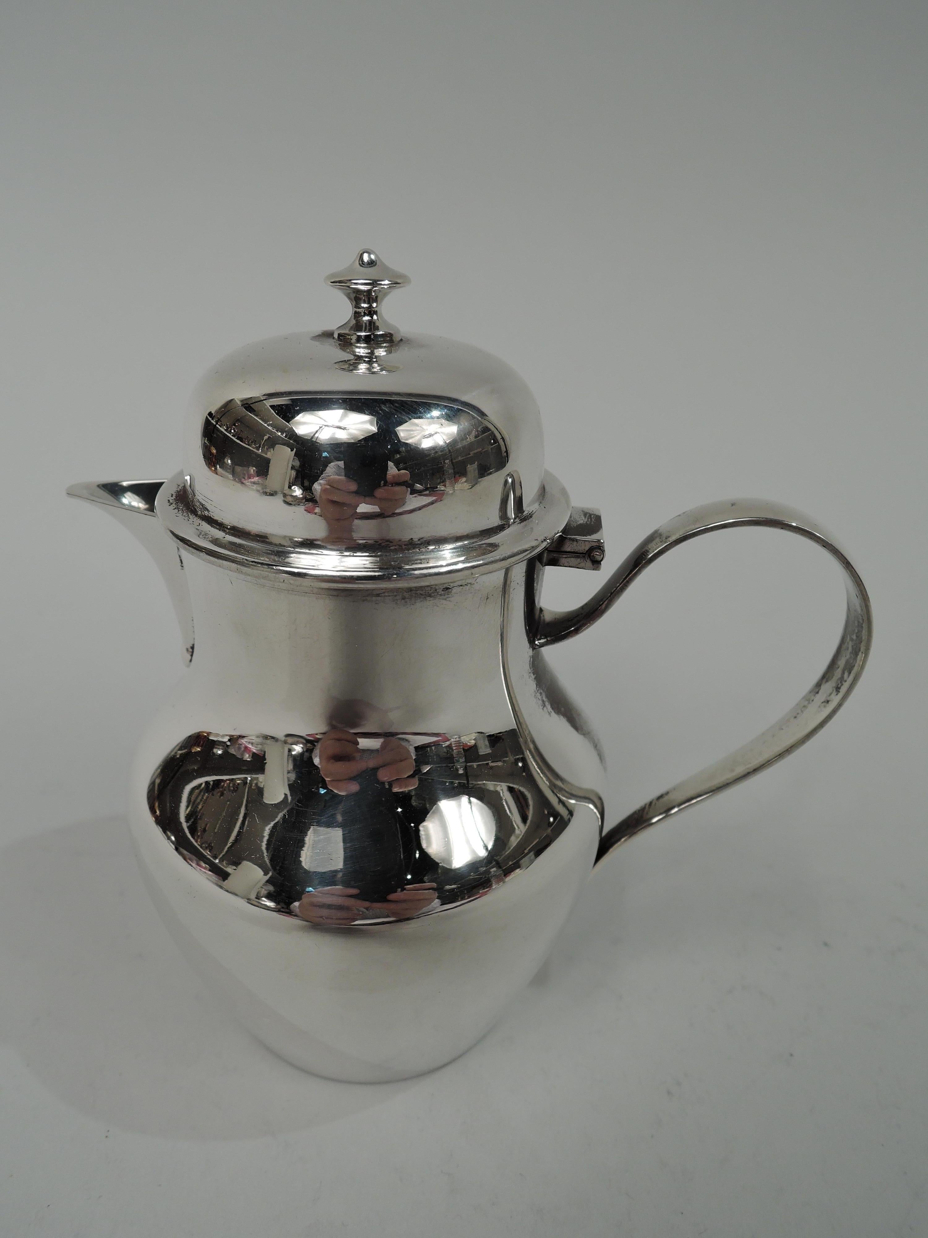 Traditional Georgian sterling silver creamer. Made by Ensko in New York. Baluster body with v-spout and high-looping handle. Cover hinged and domed with vasiform finial. Fully marked including maker’s stamp and no. 126. Weight: 6.2 troy ounces.