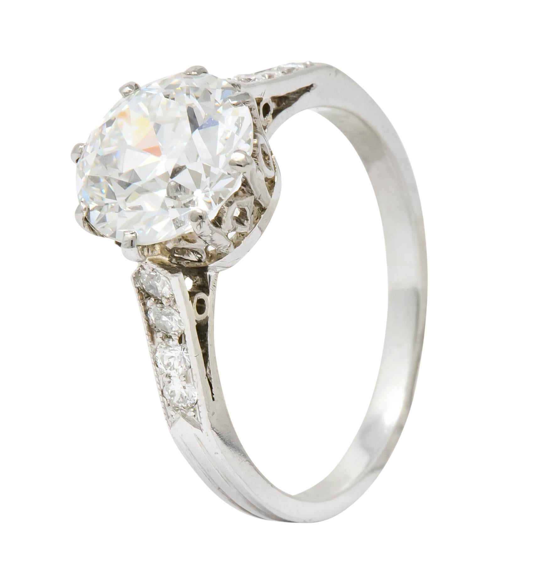 Centering an old European cut diamond weighing 2.48 carats, H color and VS1 clarity

Flanked by eight round brilliant cut diamond accents along shoulders, weighing approximately 0.20 carat, eye-clean and white

Set in a basket style cathedral