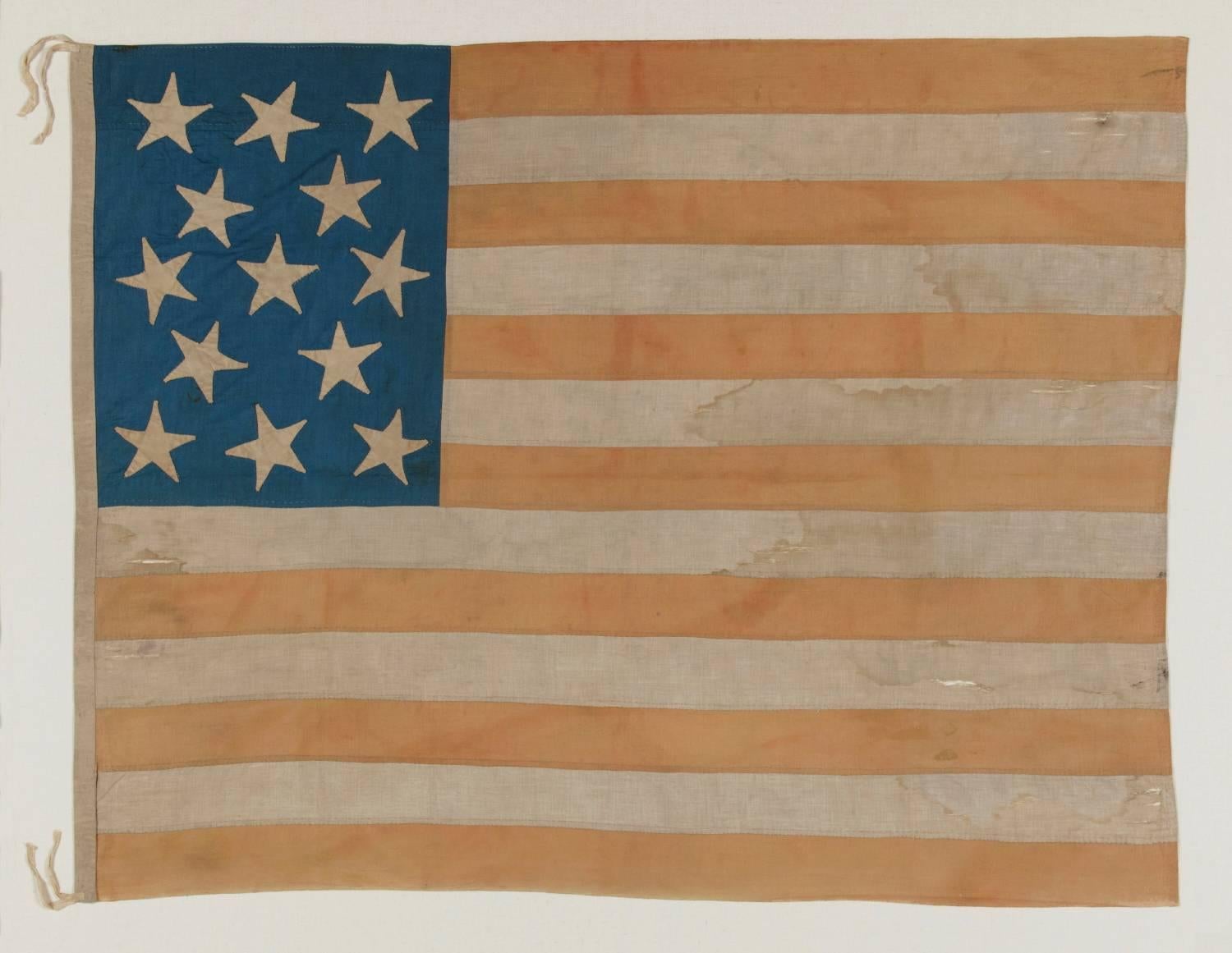 ENTIRELY HAND-SEWN AMERICAN NATIONAL FLAG WITH 13 STARS ON A TALL AND NARROW CANTON; A HOMEMADE EXAMPLE WITH INTERESTING PRESENTATION, MADE SOMETIME BETWEEN THE TAIL END OF THE CIVIL WAR AND THE 1876 CENTENNIAL:

Despite the fact that America hasn't