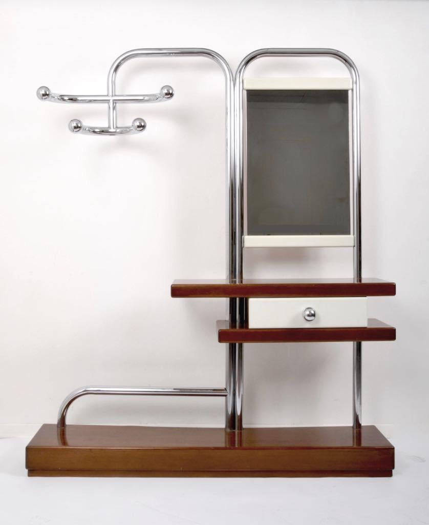 Incredible valet with oversized tubular chrome frame in a Bauhaus style. It has a four-hook bracket, a slightly smoky mirror. Wooden base, large drawer with chrome knob. Great piece for an entrance or a hall.