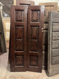 Entrance door in walnut wood, with two solid leaves, Italy