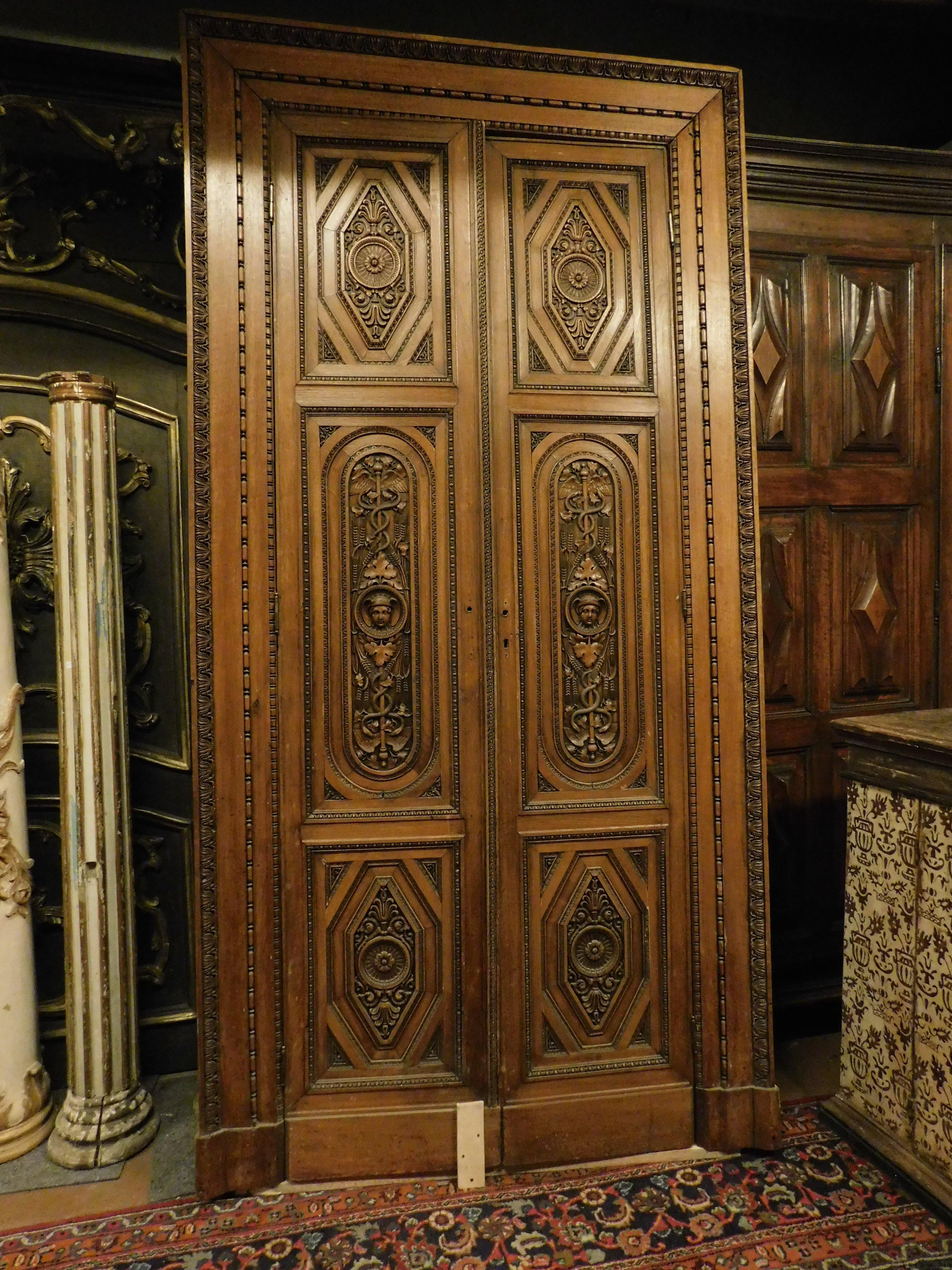 Ancient entrance door, main door richly carved by hand in precious and solid walnut wood, built for an ancient pharmacy or a doctor's office, as it has symbols of medicine such as the aesculapius. Built in the early 19th century in Italy for an