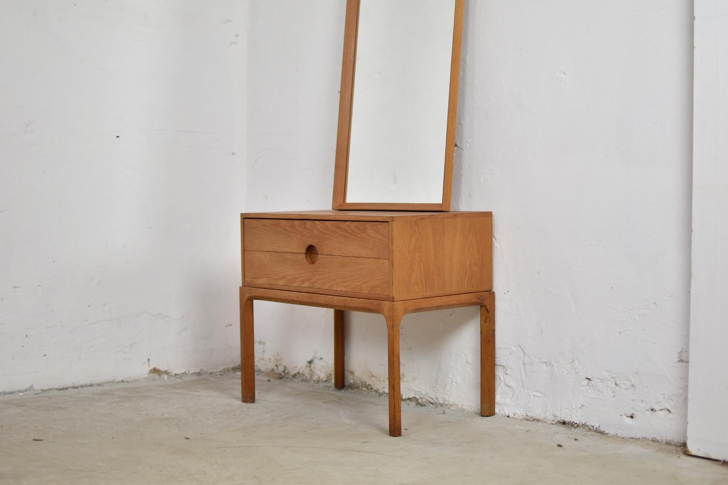 Cabinet and matching mirror by Aksel Kjersgaard for Odder Møbler, Denmark, 1960s. This entrance hall set is made out of oak. The cabinet, Model No. 384, has two marvelous shaped drawers and chamfered legs (one leg professionally restored). The