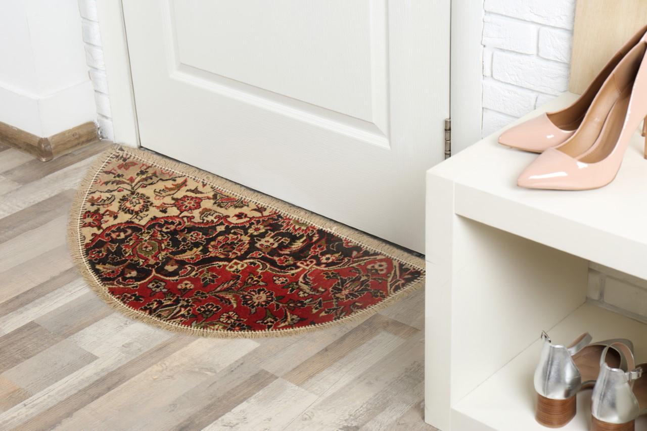 Handmade carpet Oriental rug featuring a diagonal meandering floral design, over three colors of cream, deep blue and red This semicircle entranceway doormat has been refurbished from a handmade vintage rug- cut from large area rugs to create these