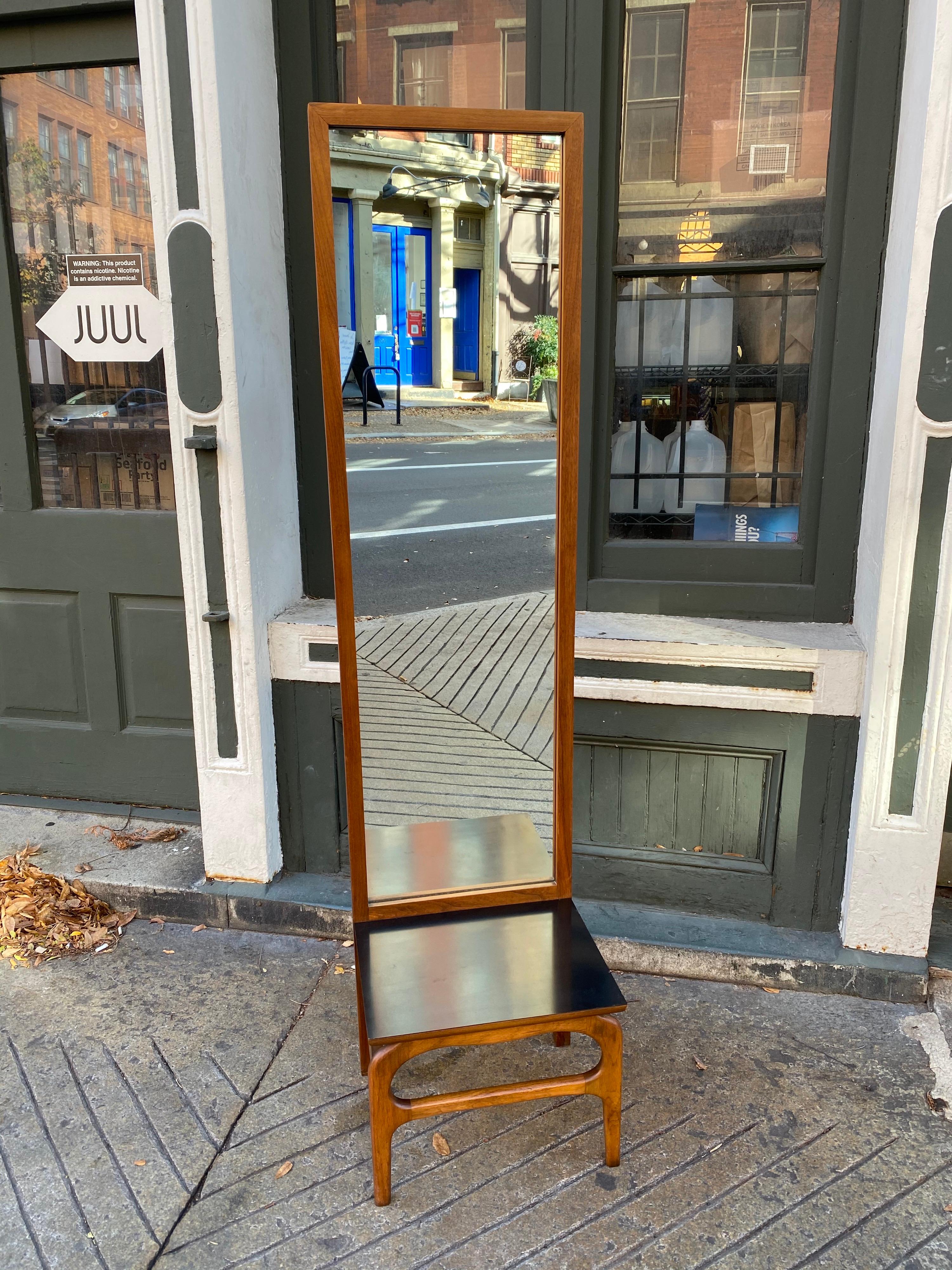 Entry/ Hallway console and mirror. Great practical design! Perfect for inside the door, throw your keys and drop the mail! Front legs have an Adrian Pearsall Design Look to them. Black Formica Surface makes it easy to maintain! Give yourself one