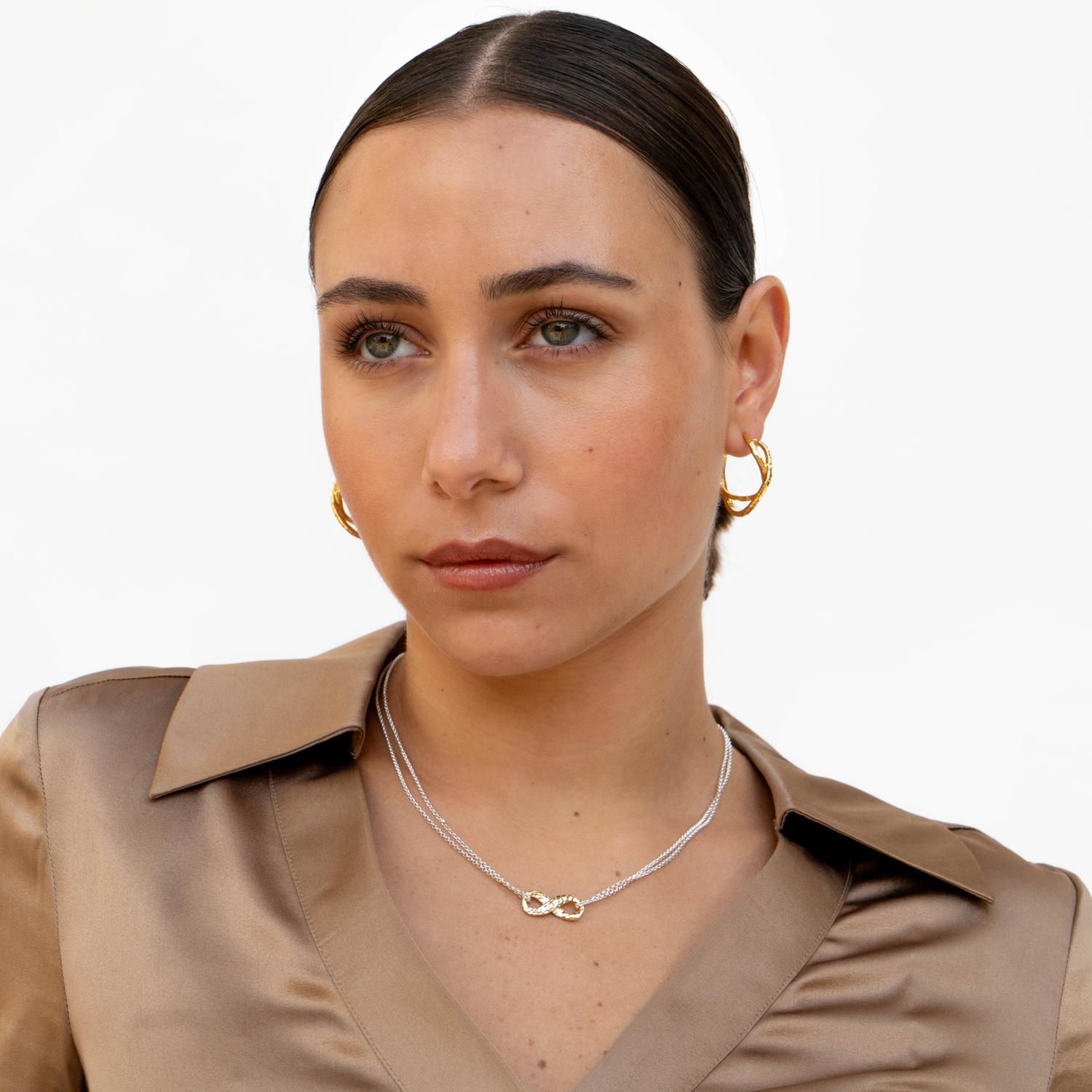 A stylish statement, these chunky sterling silver hoops are crafted with the infinity symbol, a powerful sign of endless love and connection, in a unique double twist design. The earrings are a mirror pair and are complete with our signature
