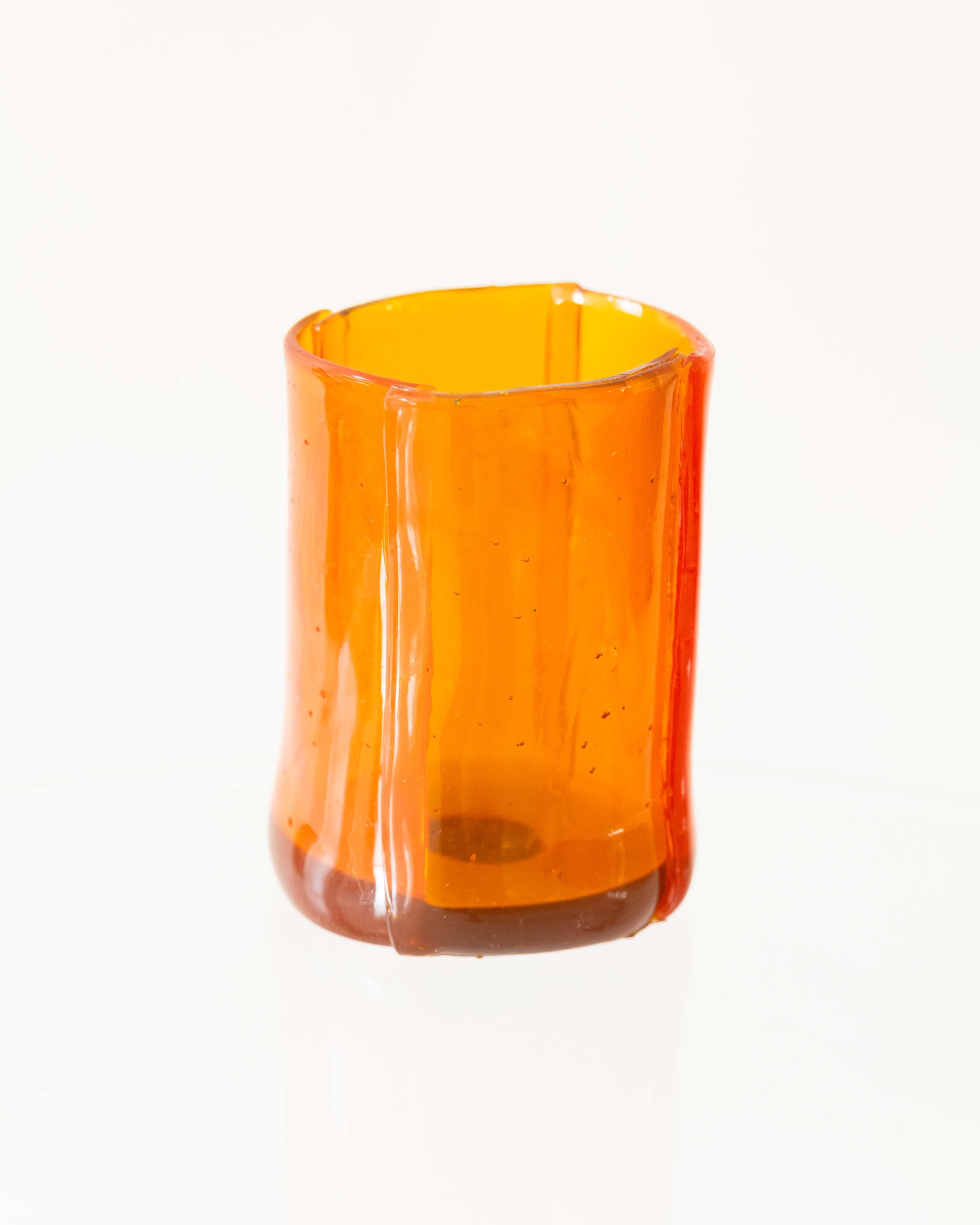 Rich amber tones and a minimalist silhouette make this Enzo Mari vase a standout. A timeless work of modern Italian design in soft resin.