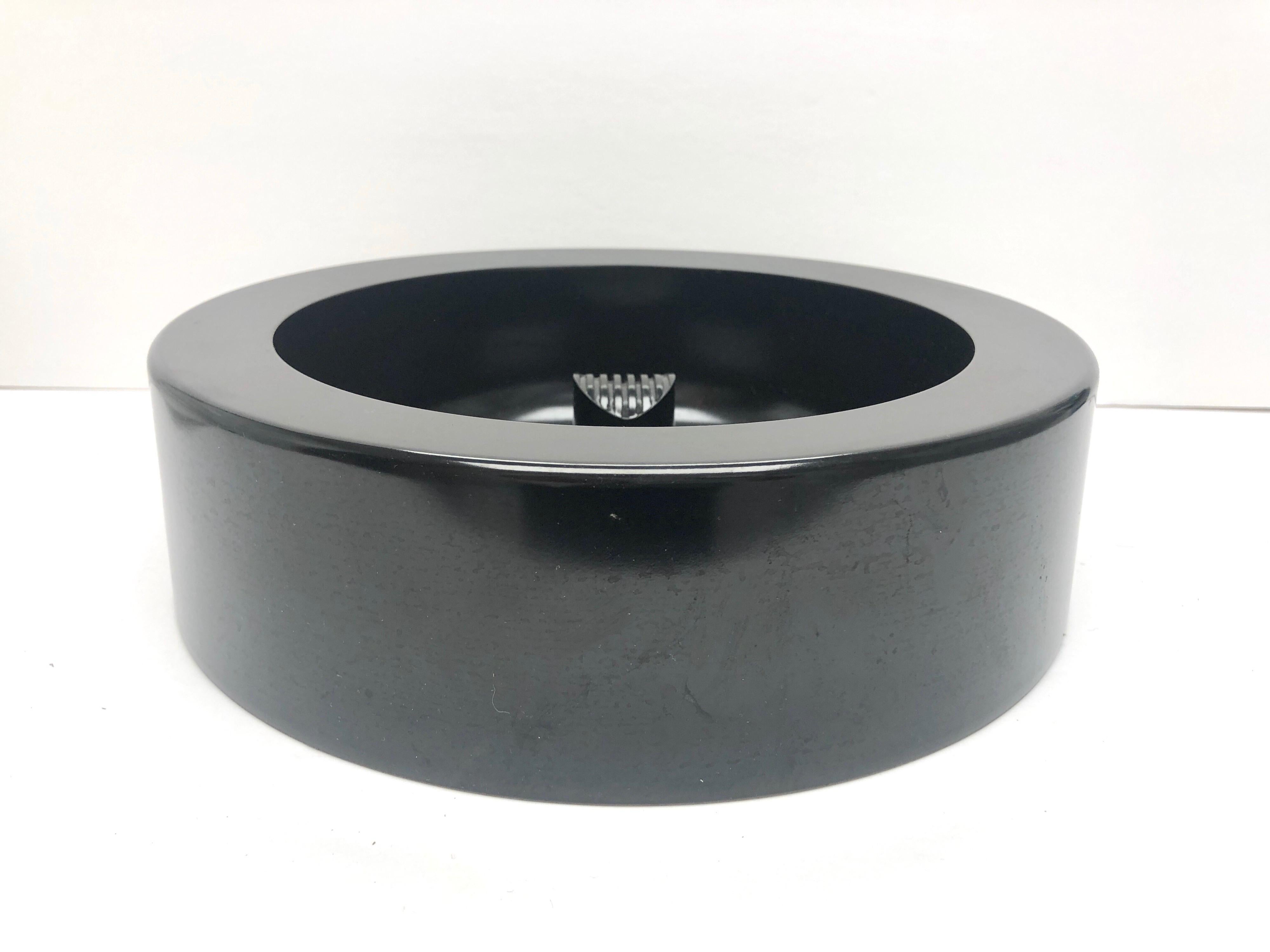 A large black melamine bowl designed by Enzo Mari, edited by Danese Milano.