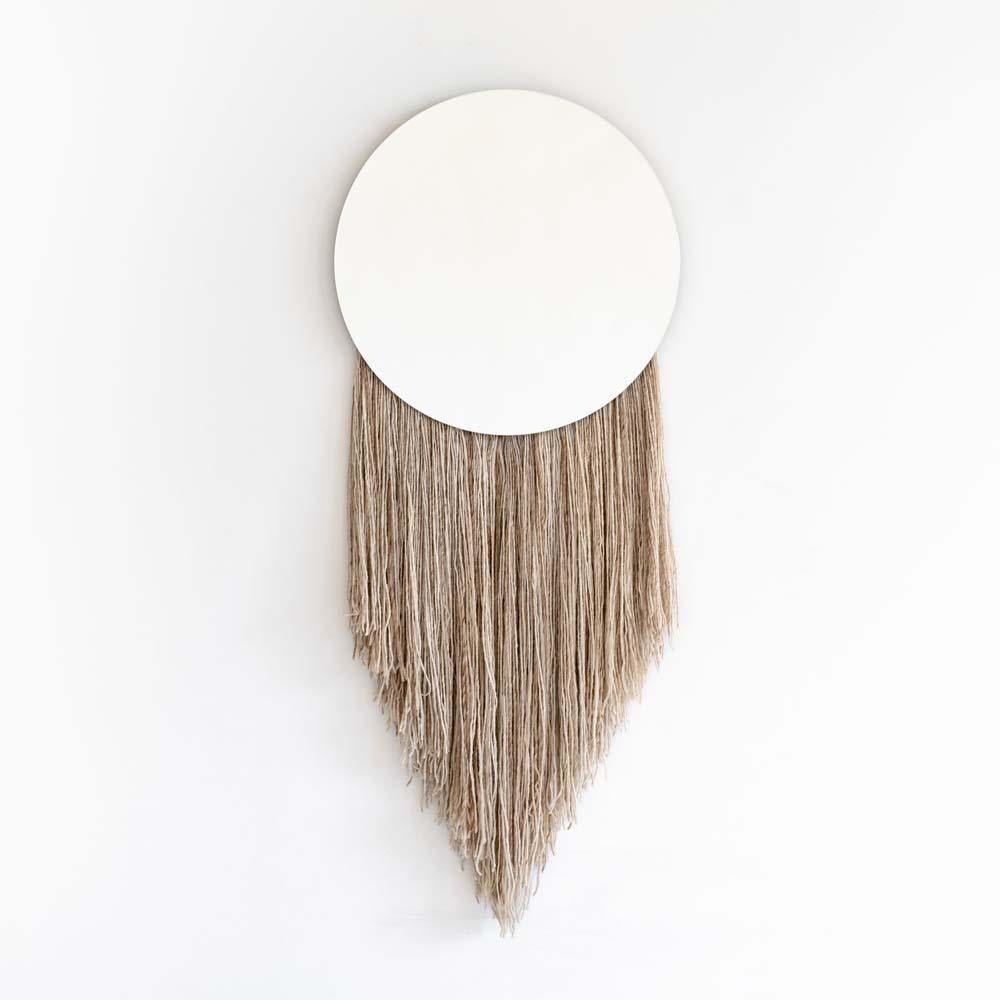 A silk fiber wall mirror in tribute to Eos
Named after the ancient Greek goddess of Dawn, the Eos mirror explores the relationship between the functional and nonfunctional elements of objects, including the utility of a mirror with the warmth and