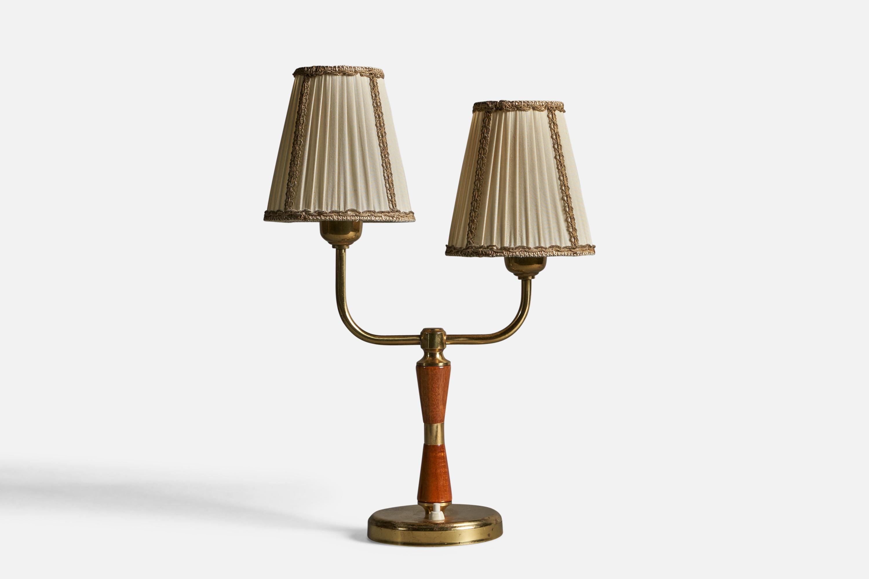 A two-armed brass, beige fabric and stained oak table lamp, designed and produced by Eos, Sweden, 1940s.

Overall Dimensions (inches): 17.25