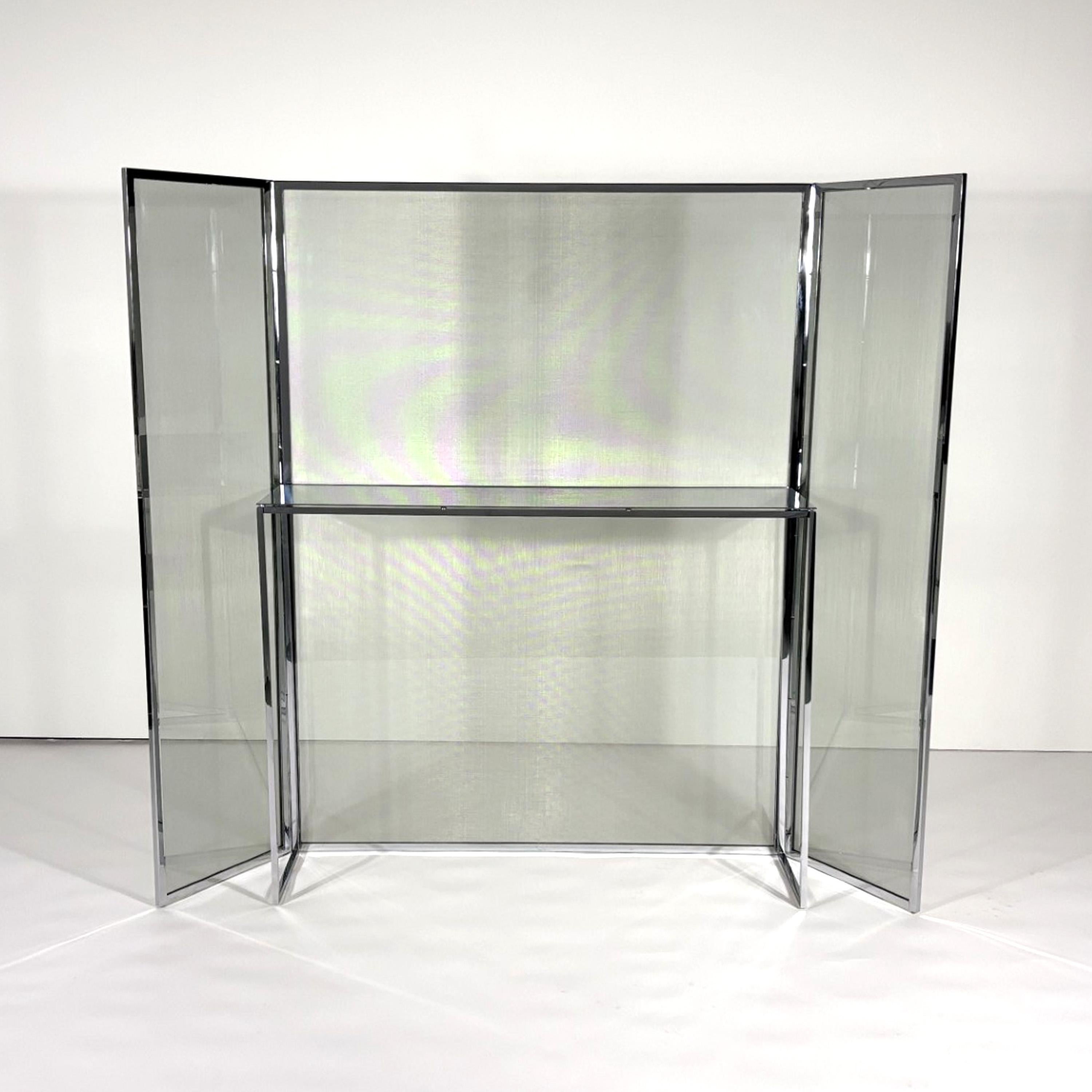 Eos Wind Screen Console by Antonio Citterio
2013
Maxalto

Chromed steel console with attached screen with two folding leaves. Steel screen which is bonded to glass creates a veiled surround to the console. 

Packaged in original crates.