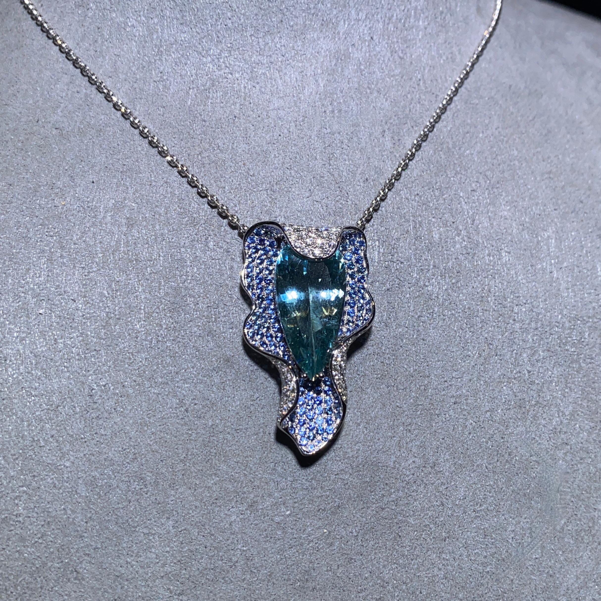 This is a Calla Lily inspired Aquamarine, Sapphire and Diamond Pendant. In the language of flowers, calla lilies mean “beauty.” The name derives from the Greek word for beauty, kallos. This flower is also associated with faithfulness and purity. On
