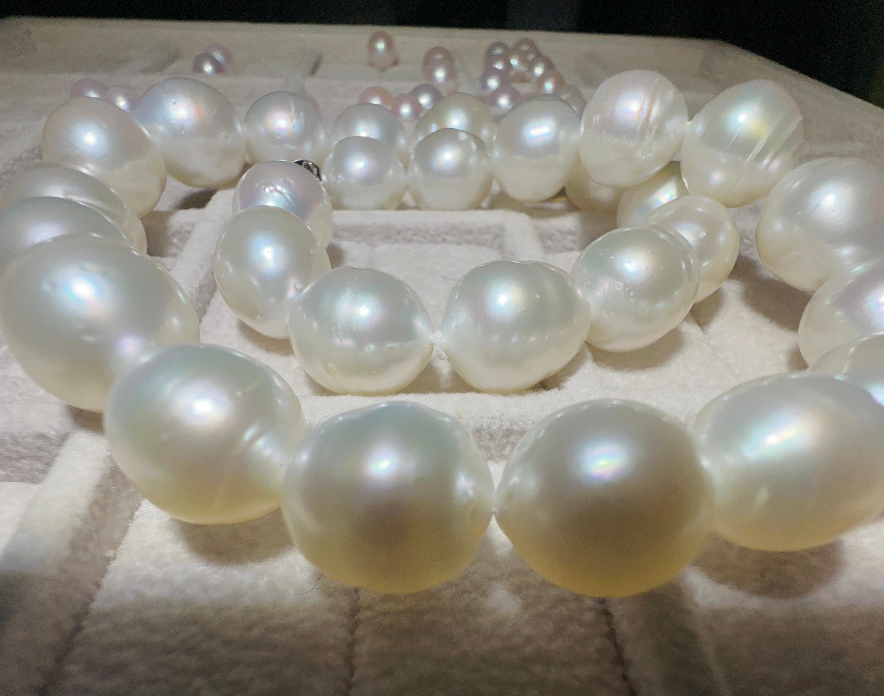 A Strand of white Colour pink tone Australian South Sea pearl necklace with 18K Gold Clasp. Pink tone is very sought after in south sea pearls and therefore more valuable. 

A 12 mm to 14.4 mm white Colour pink tone south sea Pearl Necklace. It is a