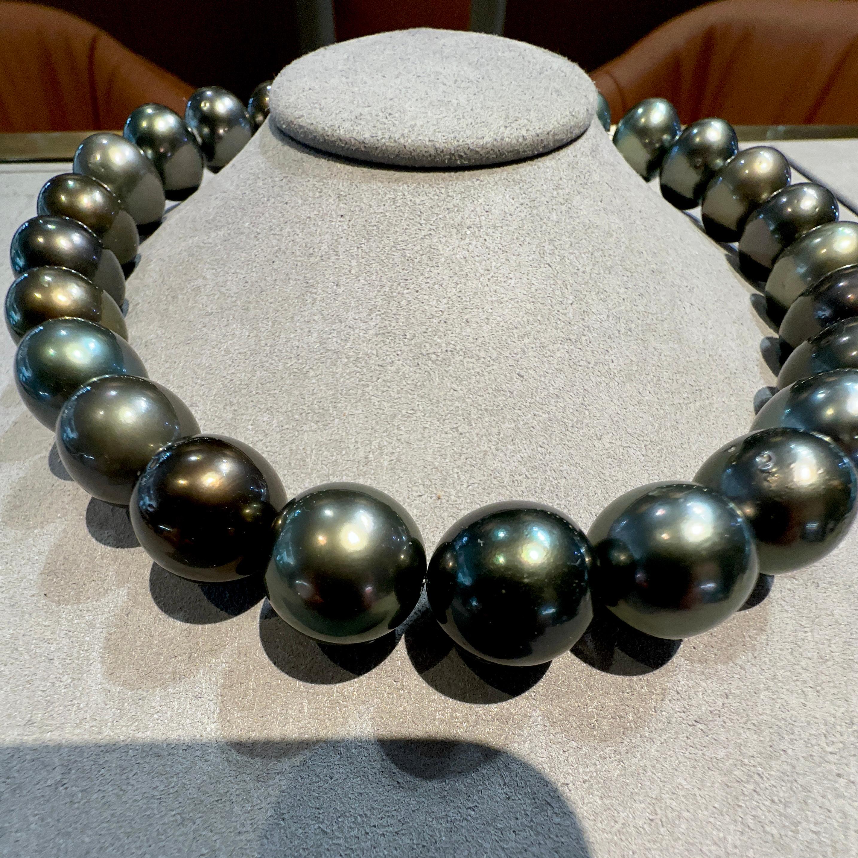 A Strand of black Colour Green tone Tahitian pearl necklace with 18K Gold Clasp. Green tone is very sought after in Tahitian pearls and therefore more valuable. 

A 14.5mm to 17 mm black Colour Green Tone Tahitian Pearl Necklace. It is a very deep