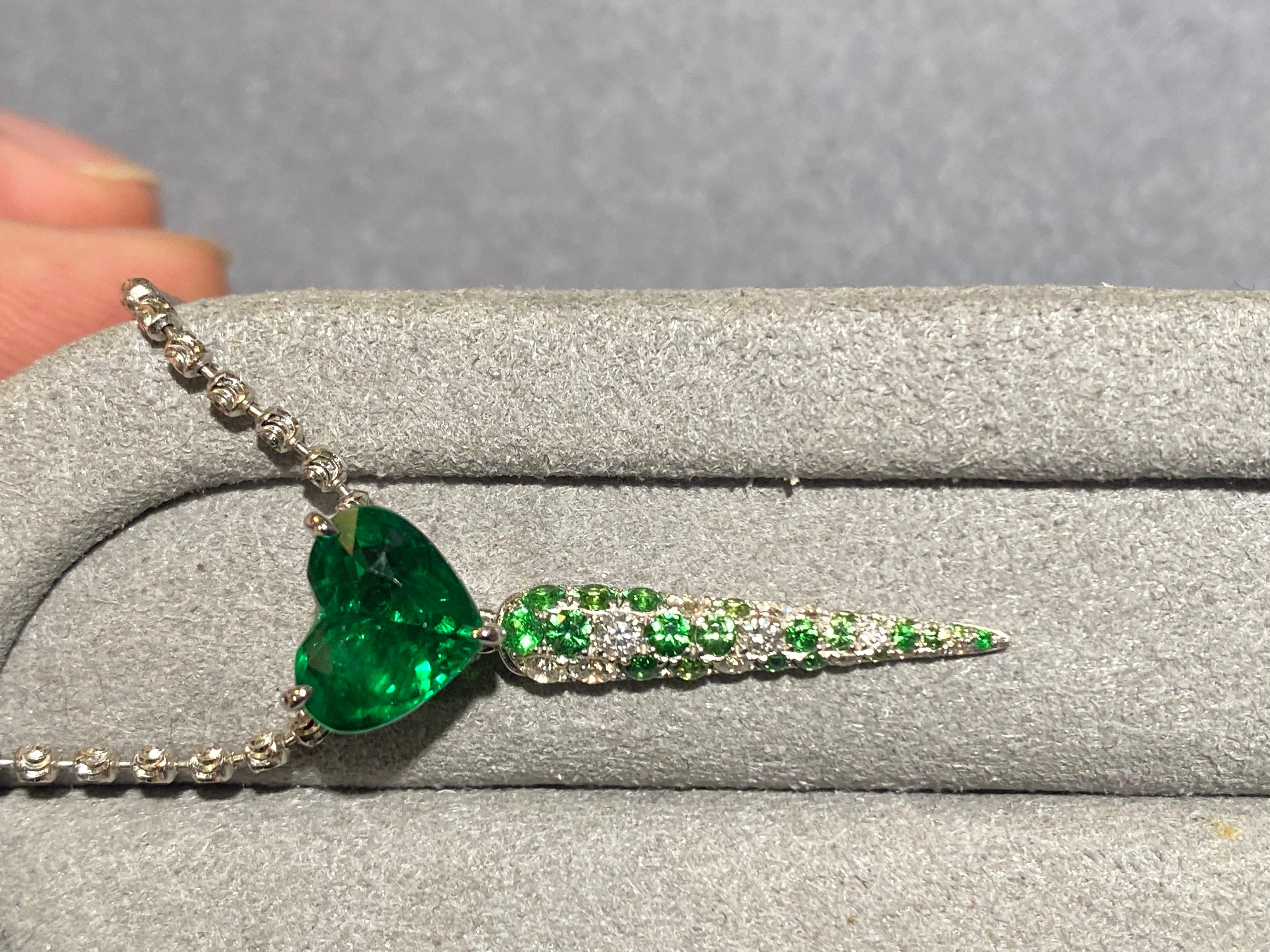 A heart shape Tsavorite garnet pendant in 18k white gold. Hanging below the heart shape Tsavorite garnet is an icicle-like drop set with micro tsavorite and diaond pave. The icicle can be removed so that the pendant becomes a simpler heart shape