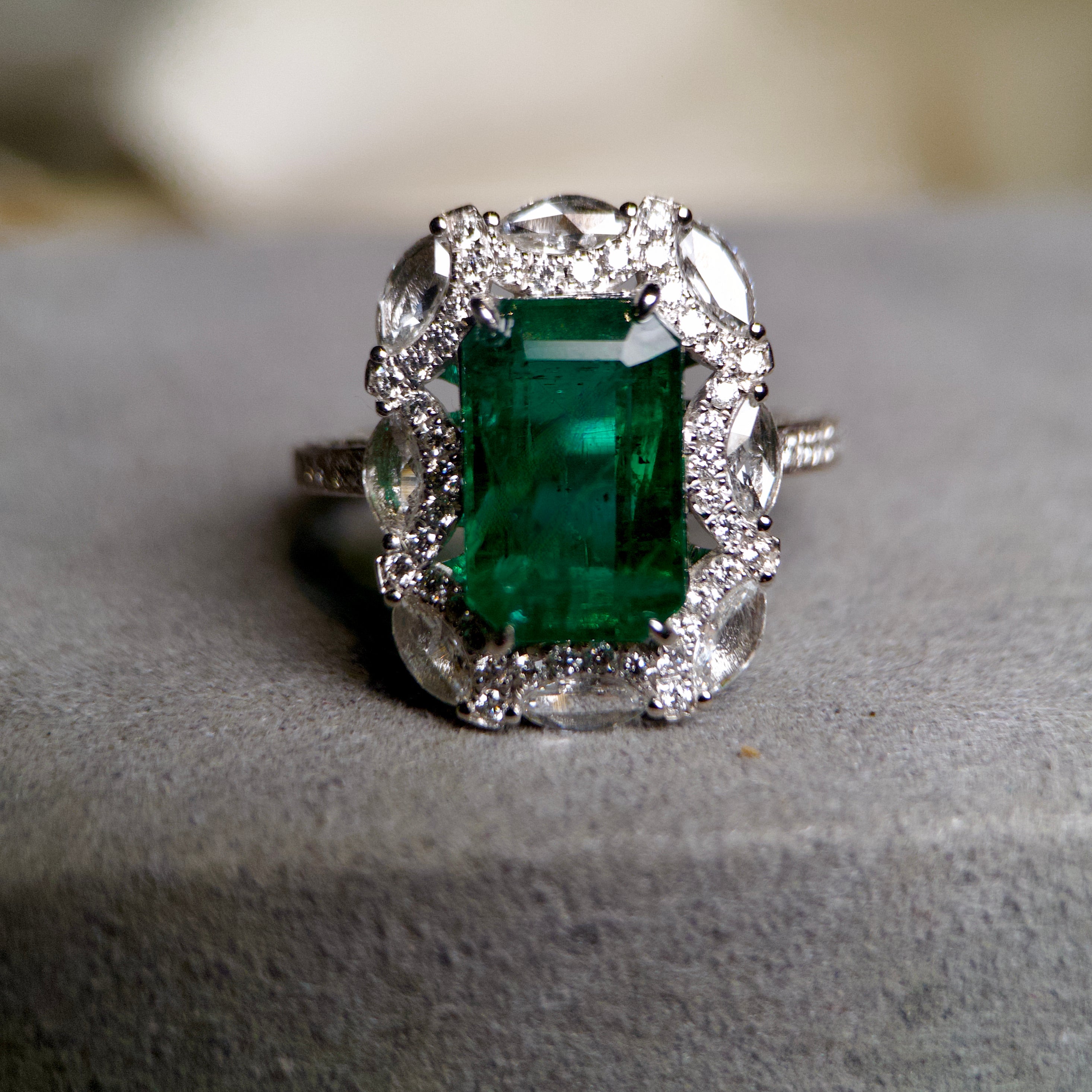 This a stunning Emerald and Diamond ring, with not only highly saturated vivid green colour emerald, but also, the tone of the emarald is on the brighter side and combining with the open back setting it really outshines others Emerald of the same