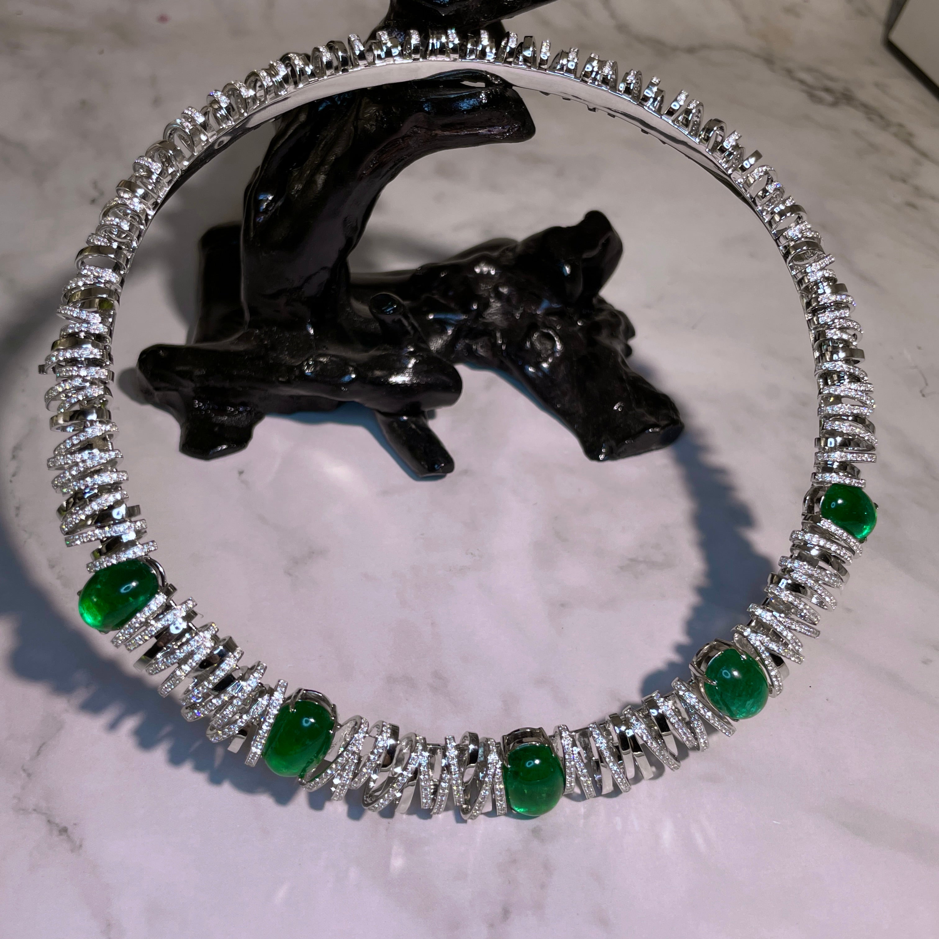 This is a statement piece highlighted with 30 carats of Muzo Green Emerald and 7.2 carats of high quality natural Diamond. This necklace is inspired by the bird nest stadium and it has a matching diamond bangle. If you love this design and wish to