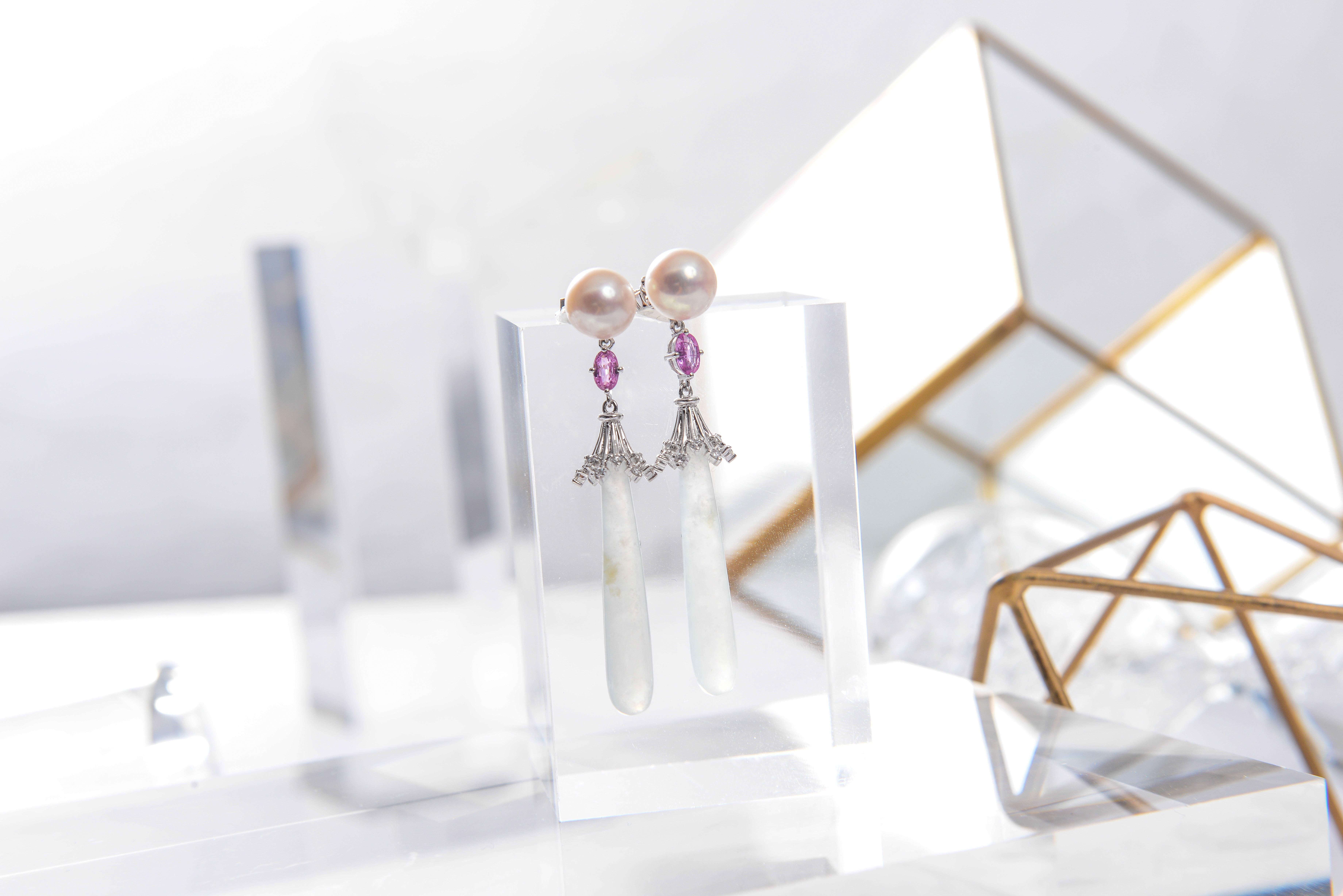 This Earring is consists of Akoya Pearls, Pink Sapphire and Jadeite. The icicle Jadeite is dangling below the Akoya Pearls connected by the pink sapphire. The pink sapphire matches the pink hue of the Akoya pearls while the near colourless icicle