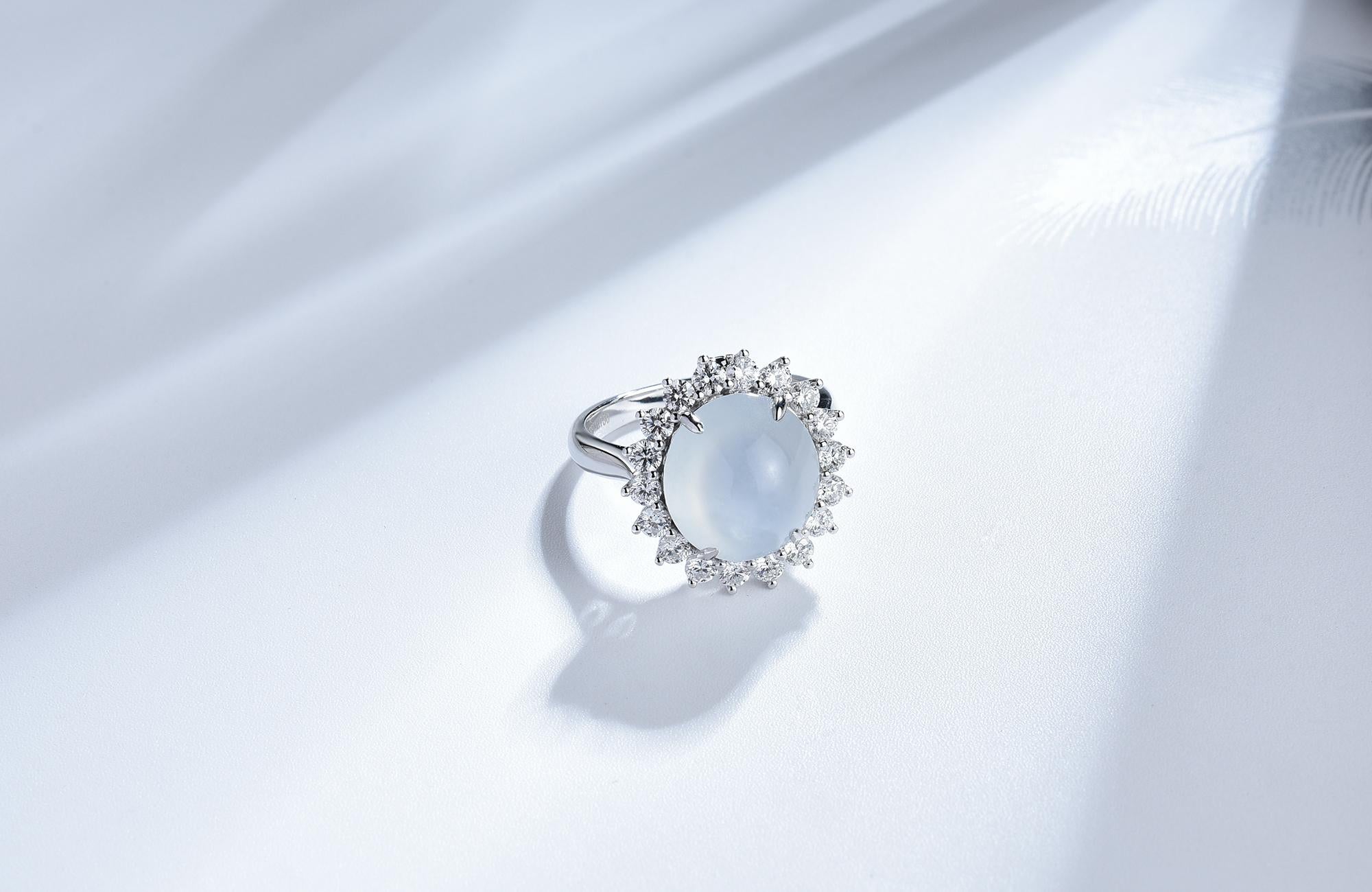 This is a convertible icy Jadeite ring/pendant. This Ring can be converted into a pendant. The near colourless icy jadeite is surrounded by diamond and forms a vintage cluster design. The jadeite can be detached from the ring and becomes a pendant.