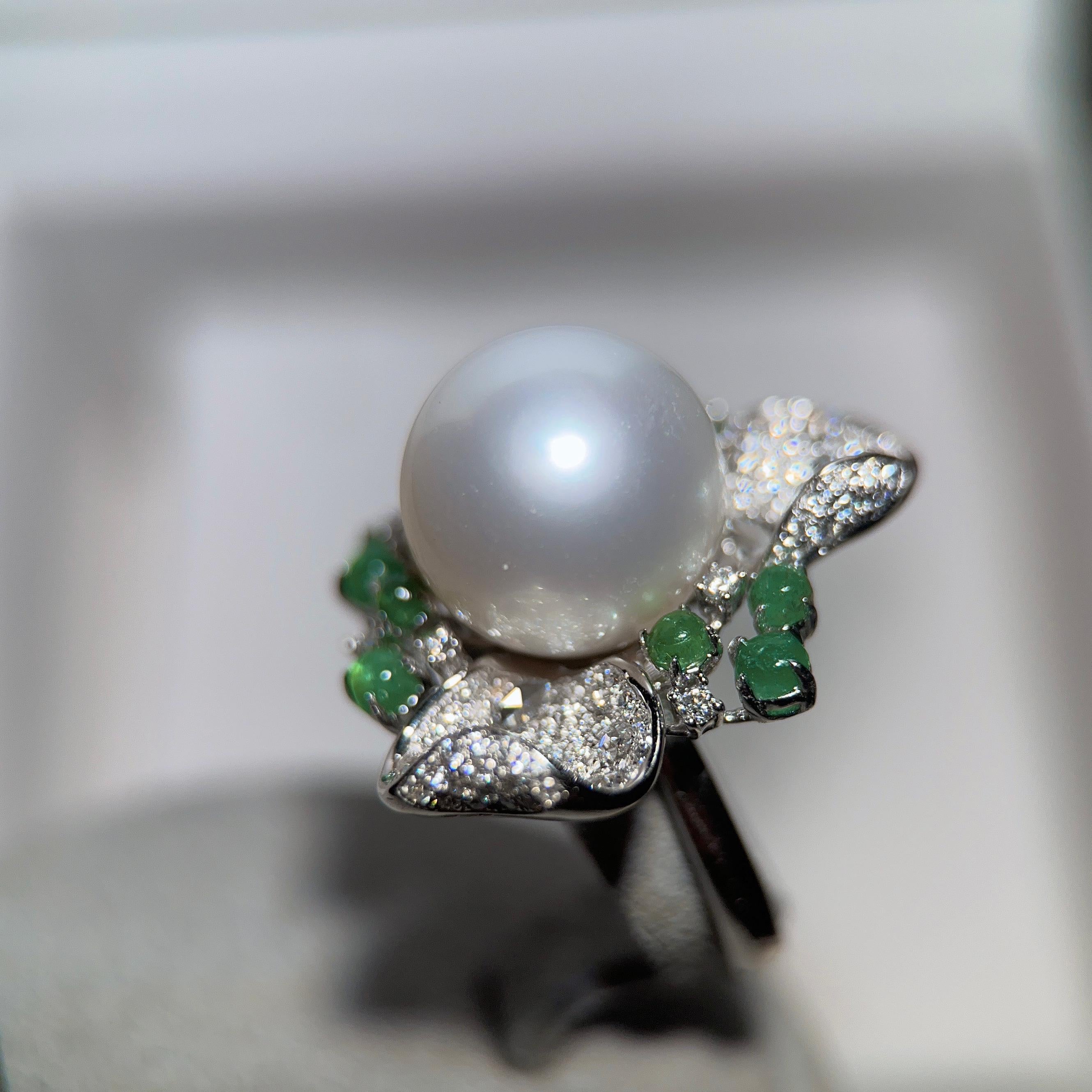 Eostre South Sea Pearl Emerald cabochon  and Diamond Ring in 18k White Gold. The pearl  is flawless with medium lustre. The colour is creamy white. The emerald cabochon is vivid green colour with great clarity.


The South Sea Pearl is  13mm
Total