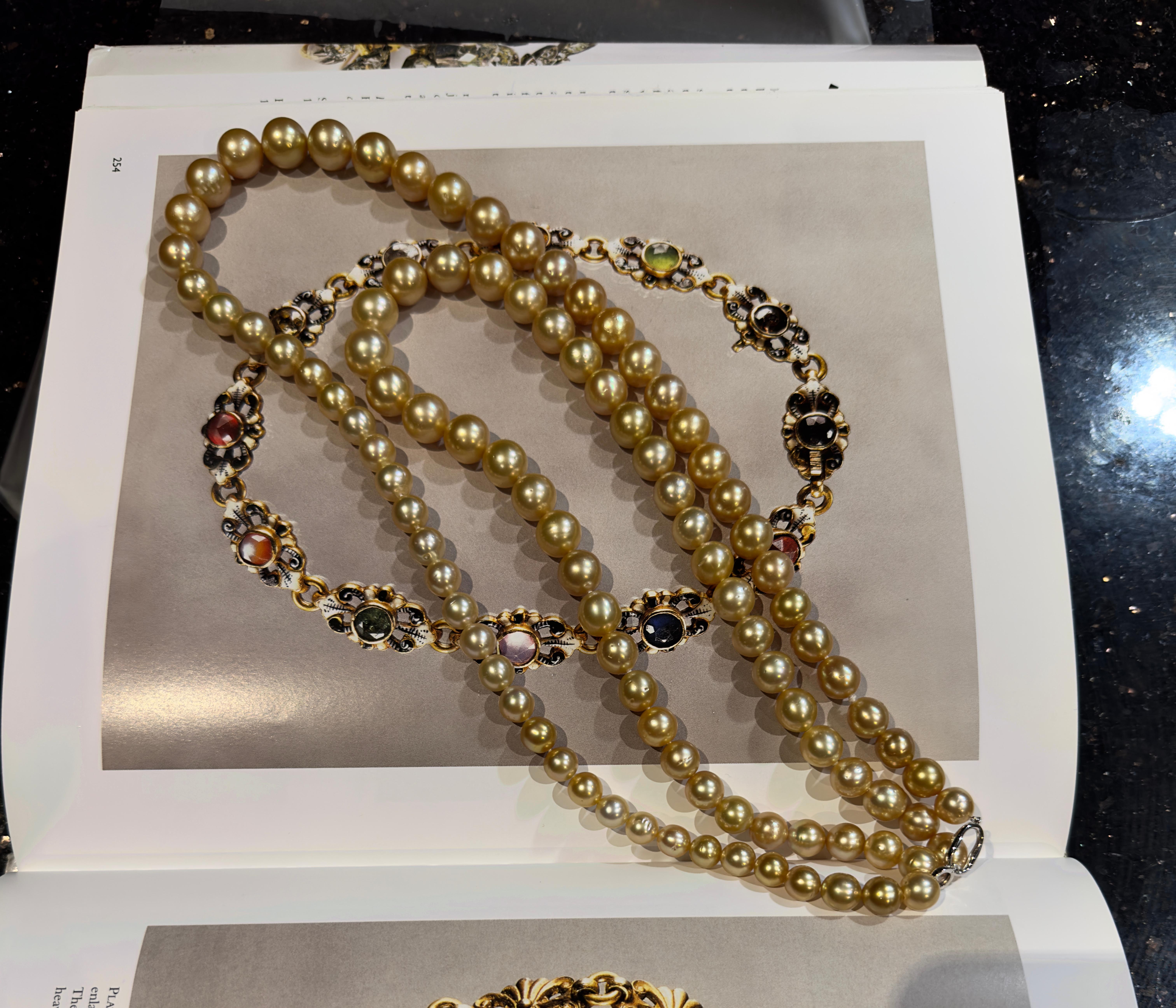 

A strand of  golden south sea pearl long chain. it consists 99 pieces golden south sea pearl,  shape of round and off round, medium to deep golden color with high lustre and pinkish overtone.
Length is 120cm
with a 18k white gold clasp
with very