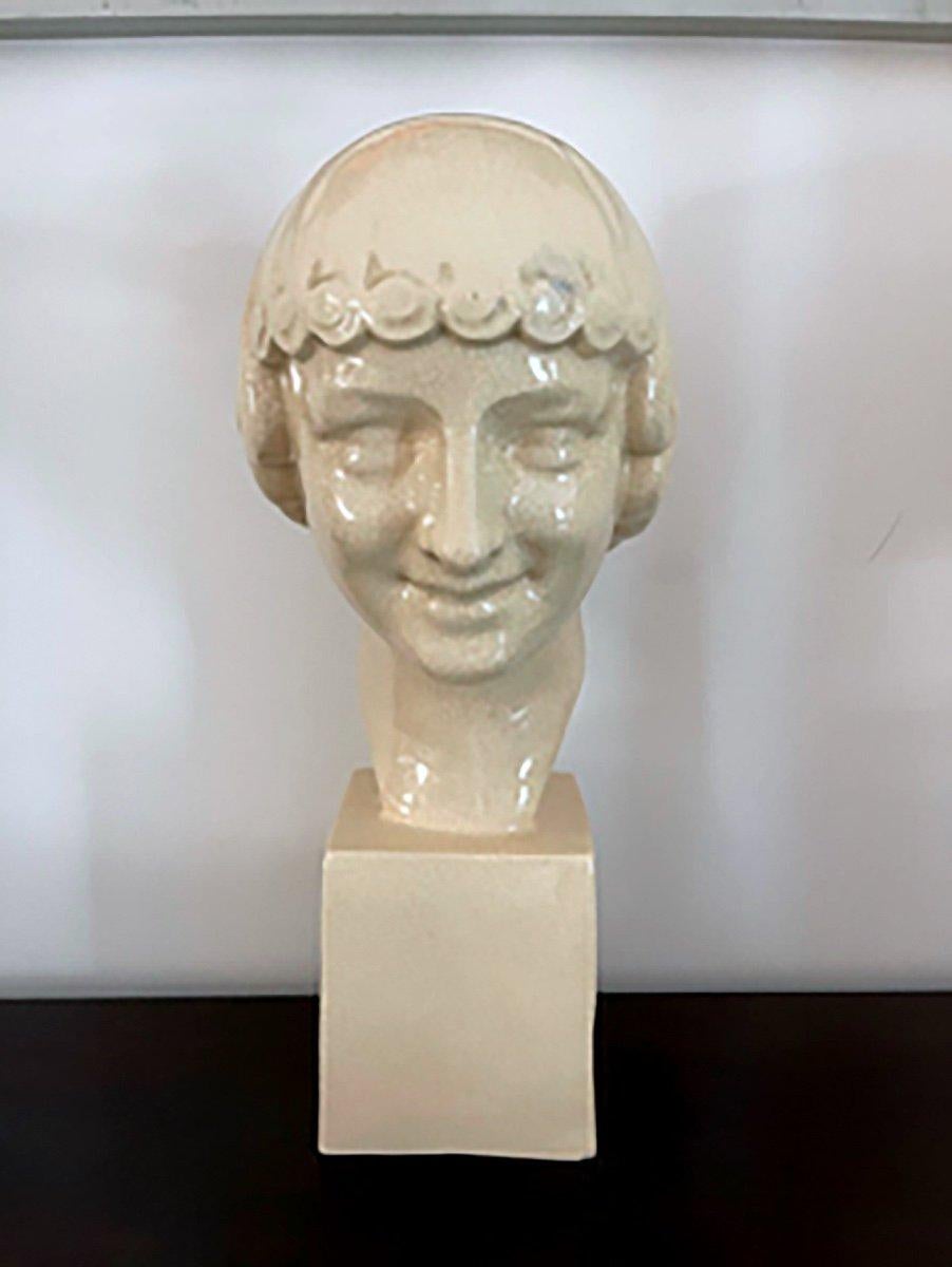 Magnificent cracked earthenware sculpture, depicting a very beautiful smiling ephebe.
The beauty of the face of this young man is represented in the purest Art Deco style, underlined even more by the treatment of the hair very in accordance with