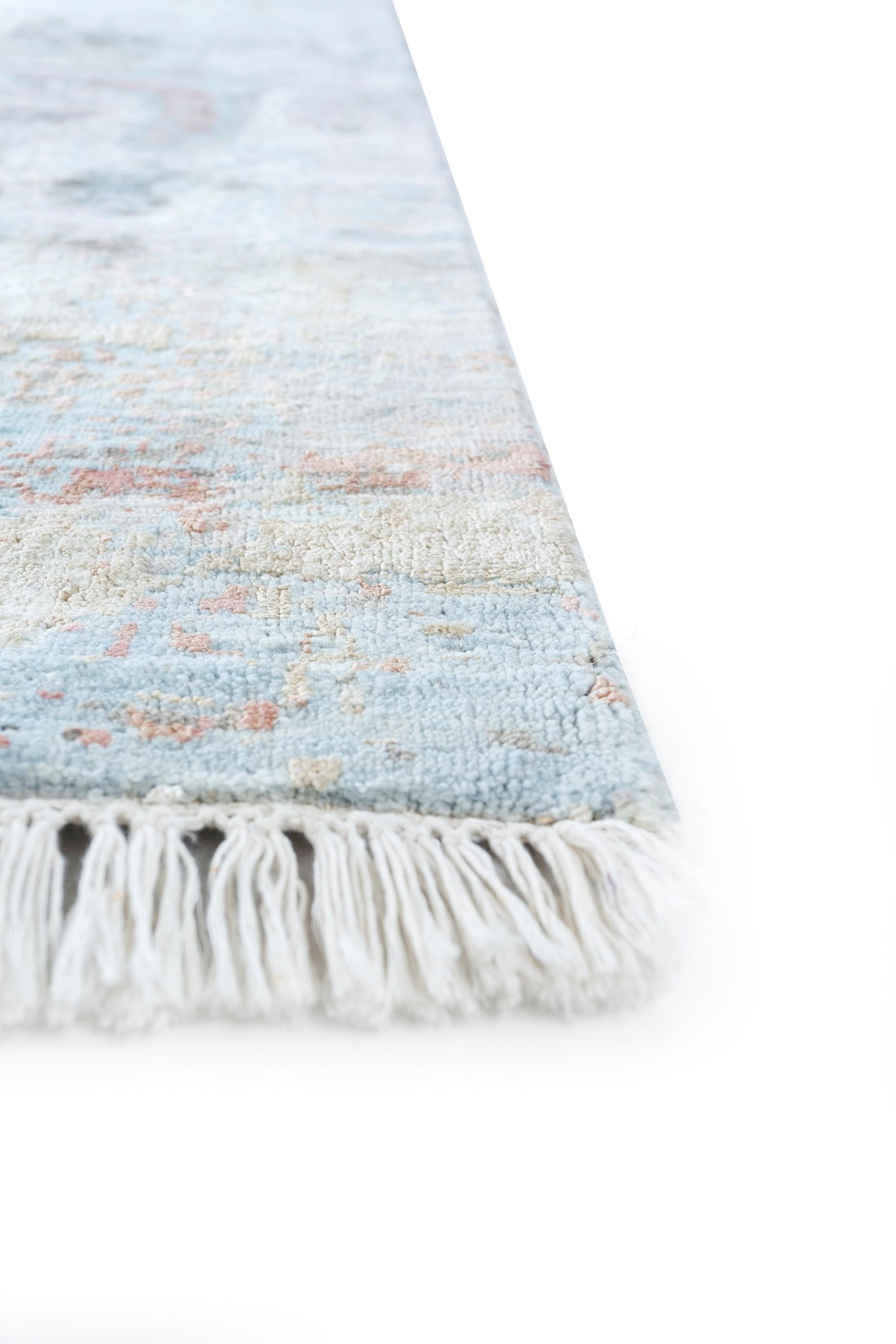 Picture the gradual decline of civilizations reflected in the patterns of 'Ephemeral Echoes,' a mesmerizing hand-knotted rug that speaks to the delicate dance between disorder and tranquility. Crafted in rural India, this modern design captures the
