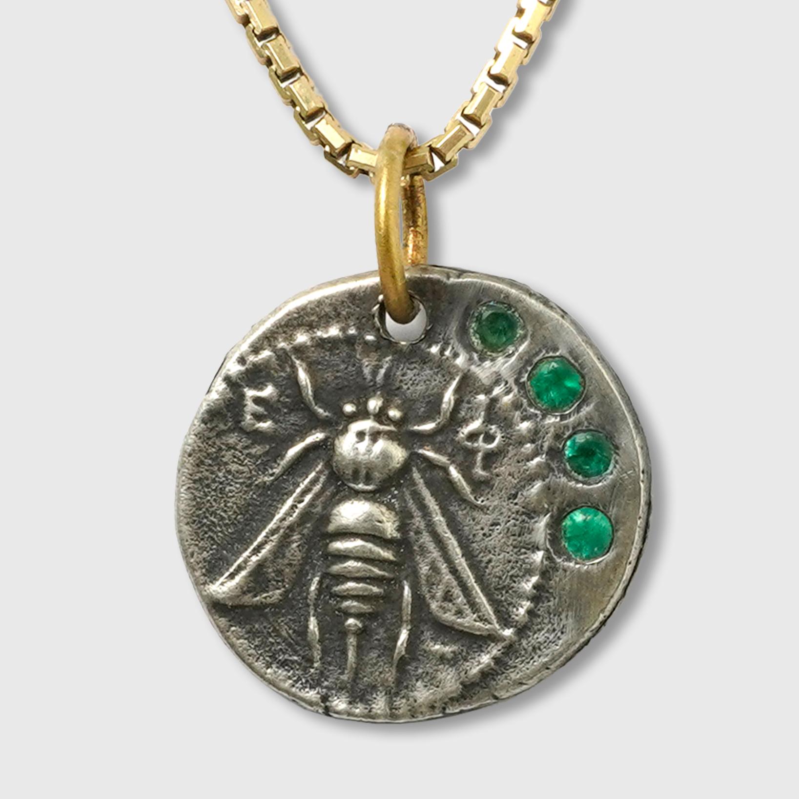 Ephesus, Queen Bee, Tetra Drachm, Charm Pendant, 24kt Yellow Gold, Silver & 0.10ct Emeralds.

Sterling Silver coin is a replica coin from those in the Turkish Museum. 390–380 B.C., Coin (tetradrachm) of Ephesos

Size - Small, 5/8
