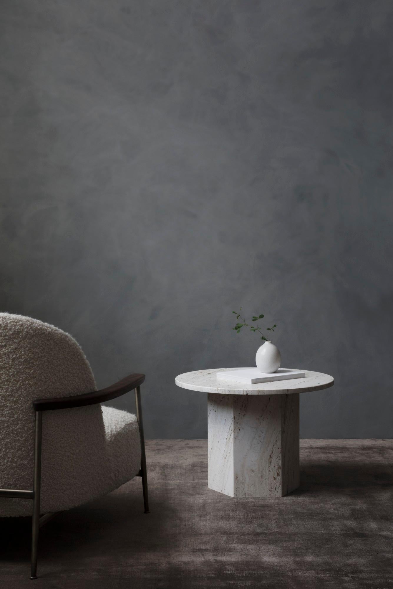 Named after the epic poems of ancient times, GamFratesi’s Epic Table for GUBI is a sculp- tural piece of furniture inspired by Greek columns and Roman architecture. 
Originally made in Italy from travertine stone, the table’s new variant marks the