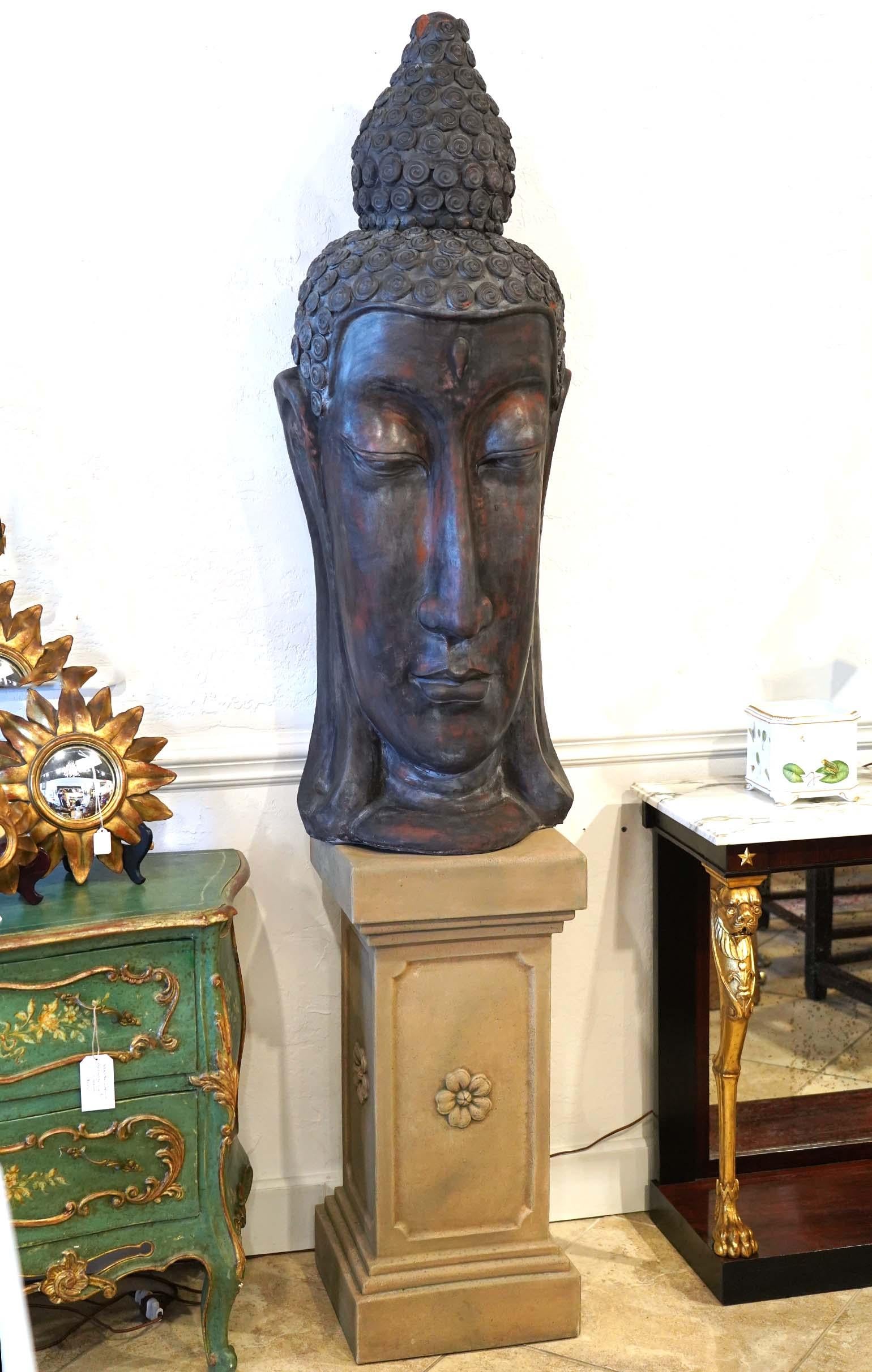 Standing 52 inches tall this Buddha will look very impressive both outdoors and indoors environment. It likely dates to the late 20th century and is created for decorative purposes. The facial details are elegant and well sculpted. The traditional