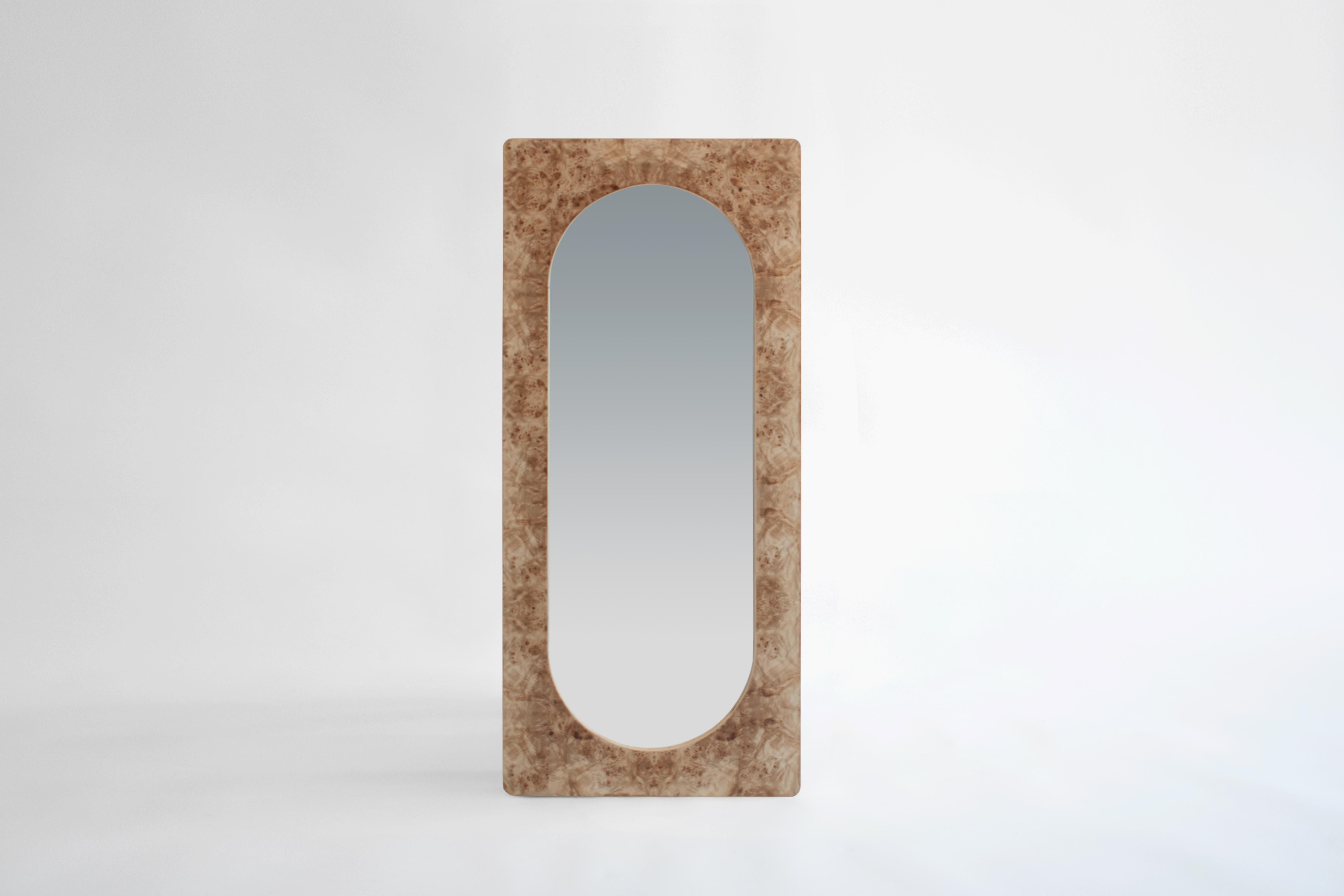 Wall mirror (for leaning or hanging) made of wood and mappa burl veneer.

This mirror piece draws inspiration from its twin mirror pieces in the collection. Liberated from its plinth, this leaning version is applicable both vertically and