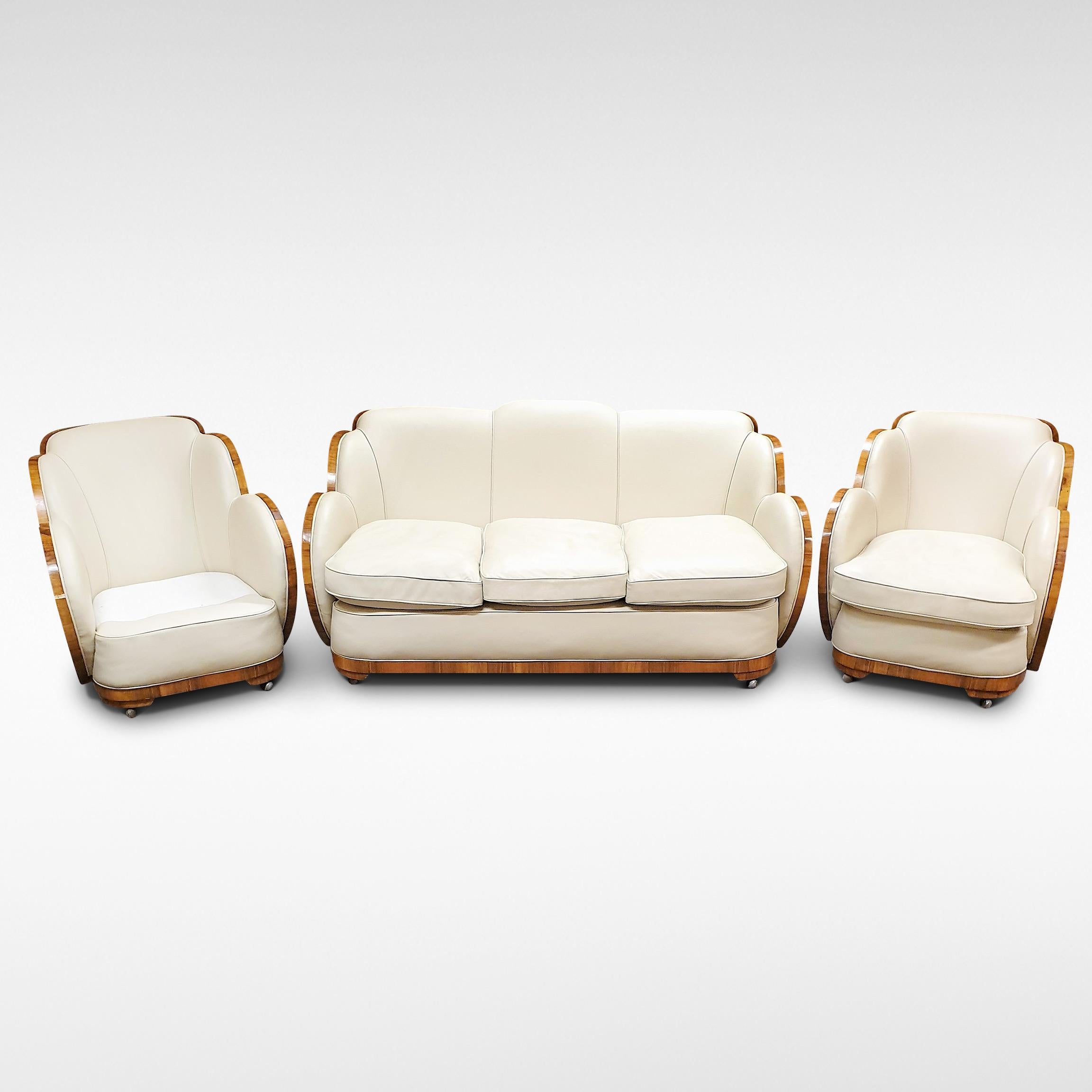 A superb example of the Art Deco cloud lounge suite by Epstein with full wrap-around walnut veneers. The 3- seat sofa and 2 armchairs are upholstered in leather. Dates from circa 1935-1955

The price includes full restoration using original