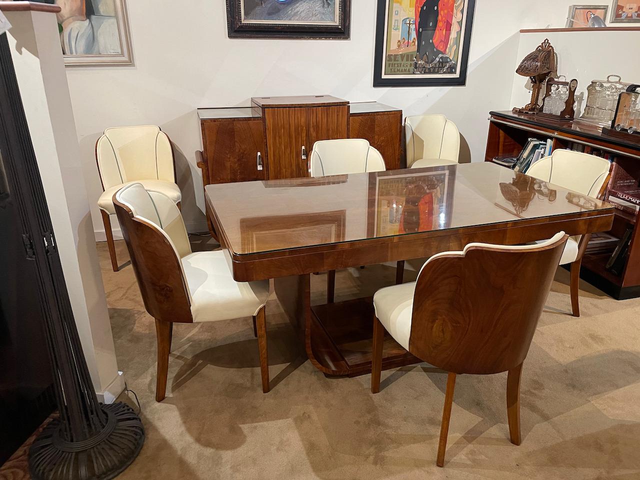 A stunning original Art Deco period buirl walnut dining suite by Epstein. This consists of six amazing cloud-back dining chairs and a twin pedestal dining table. This is all made from stunning burl walnut, the dining table has original glass custom
