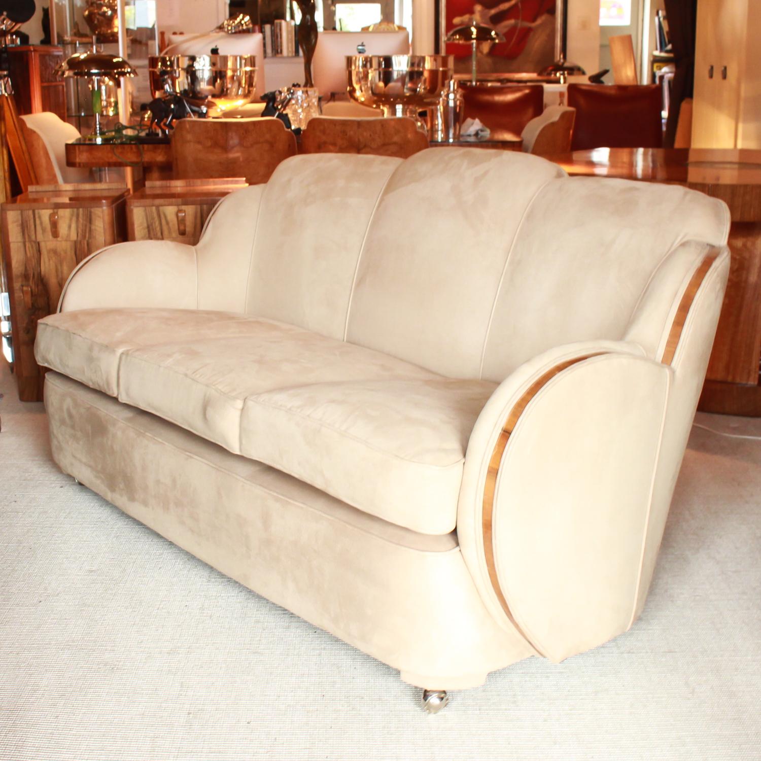 An Art Deco three-seat sofa by Harry and Lou Epstein. Walnut banding to arms, upholstered in Alcantara suede. Replacement castors.

Dimensions: H 85 cm, W 165 cm, D 80 cm, seat H 50 cm, seat D 60 cm

Origin: English

Date: 1930


  