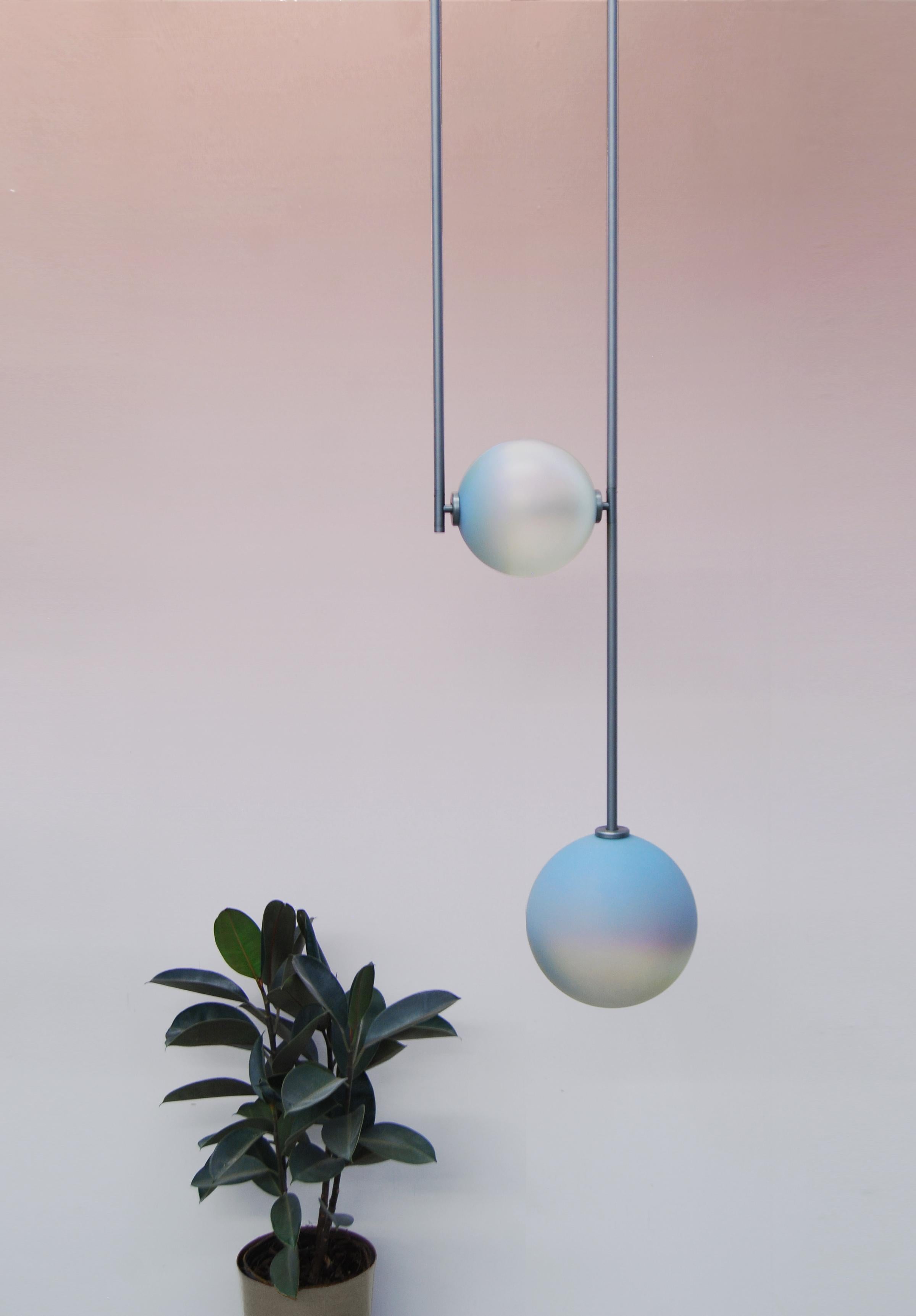 Equalizer chameleon globe pendant light by Ladies & Gentlemen Studio 
Dimensions: Height variable, 12” round canopy
Materials: Copper, brass, wire, cord
Finishes: Black anodize/bronze 
 Anodize/olive anodize
 Glass: cream/smokey