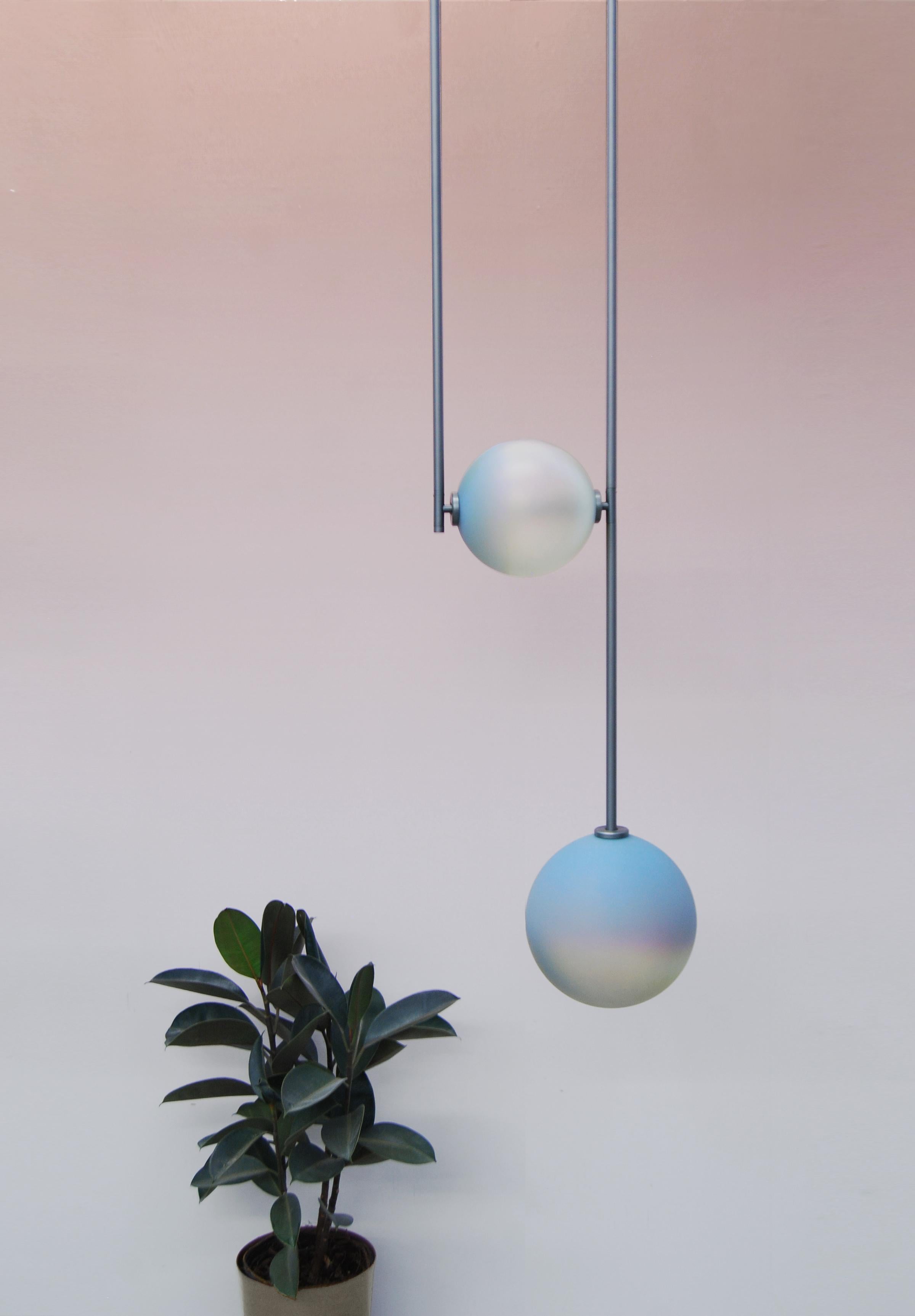 Equalizer chameleon globe pendant light by Ladies & Gentlemen Studio.
Dimensions: height variable, 12” round canopy.
Materials: copper, brass, wire, cord.
Finishes: black anodize / bronze.
 anodize / olive anodize.
 glass: cream / smokey green