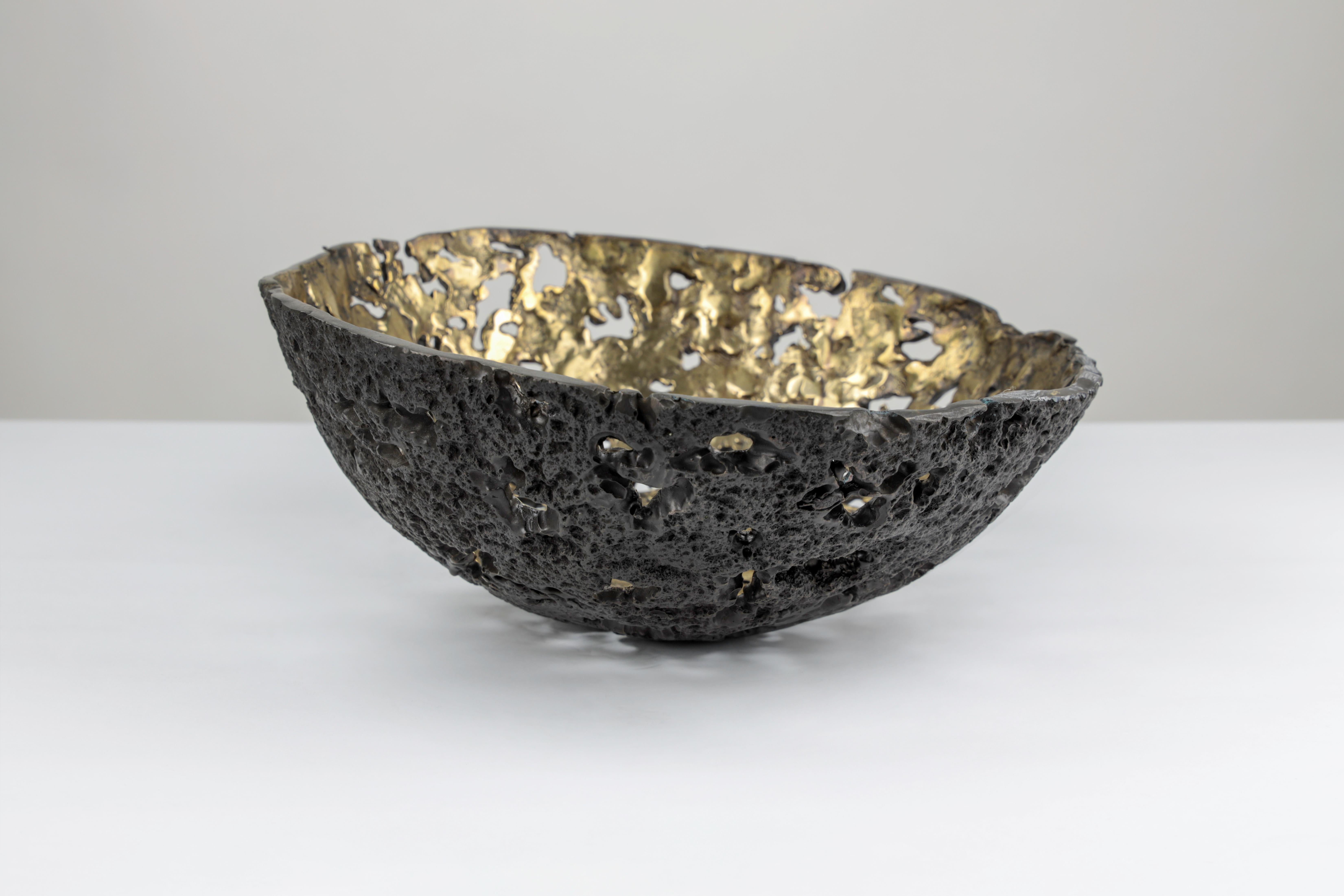 The equator bowl is a Brutalist sculpture made of hand carved craters throughout its bronze body.
The outer surface is a blackened patina and the inner is a matte shiny raw bronze. Signed.
Made in Los Angeles.

  