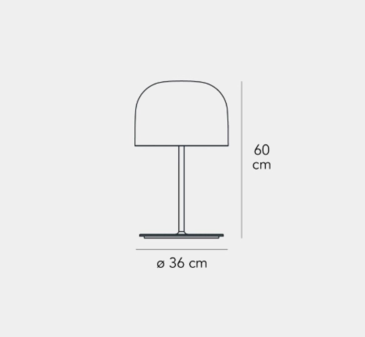 Equatore ist eine moderne Neuinterpretation der klassischen Lampe mit Glasschirm. Während bei der traditionellen Abat-Jour der Schirm die Lichtquelle einschließt, ist er bei dieser Lampenfamilie paradoxerweise leer. Das Licht wird von zwei