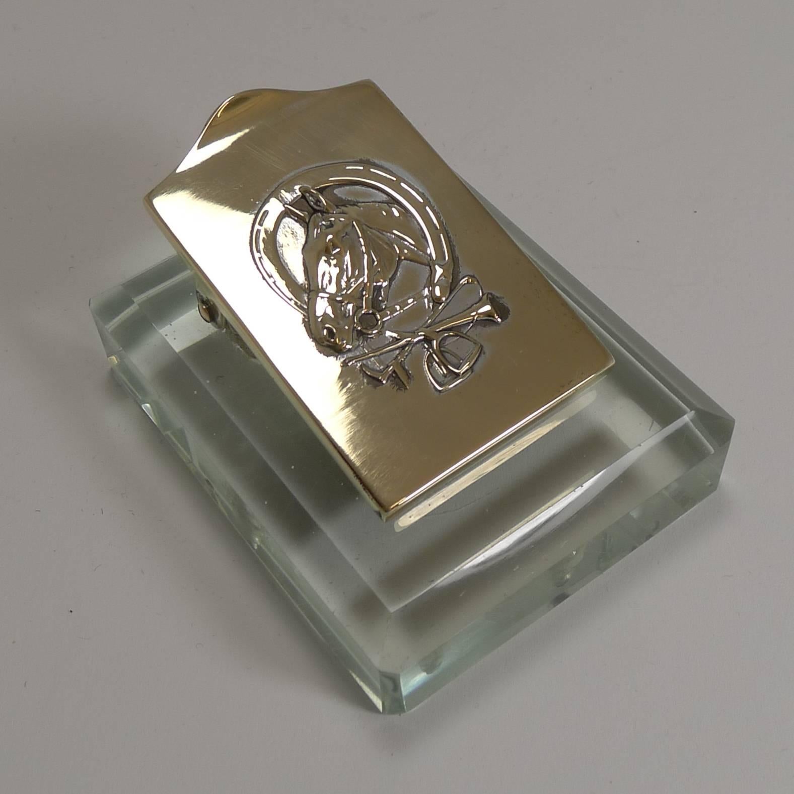 A charming and unusual desk-top letter clip, perfect for business cards, letters, receipts etc. With it's heavy glass base, it would also double as a paperweight.

The hinged polished brass clip features a horse head framed by a horseshoe and