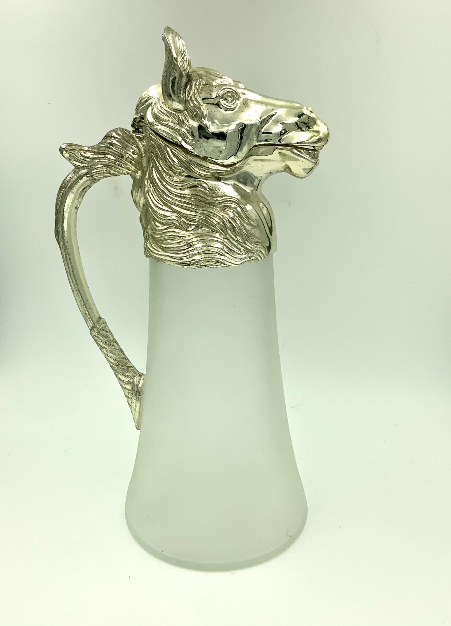 Vintage 1970s nickel silver plated horse head pitcher that opens by pulling back on the ears. The horse head and mane is mounted on a frosted glass to make a gorgeous figural decanter pitcher. Part of the original sticker is still on the bottom - it