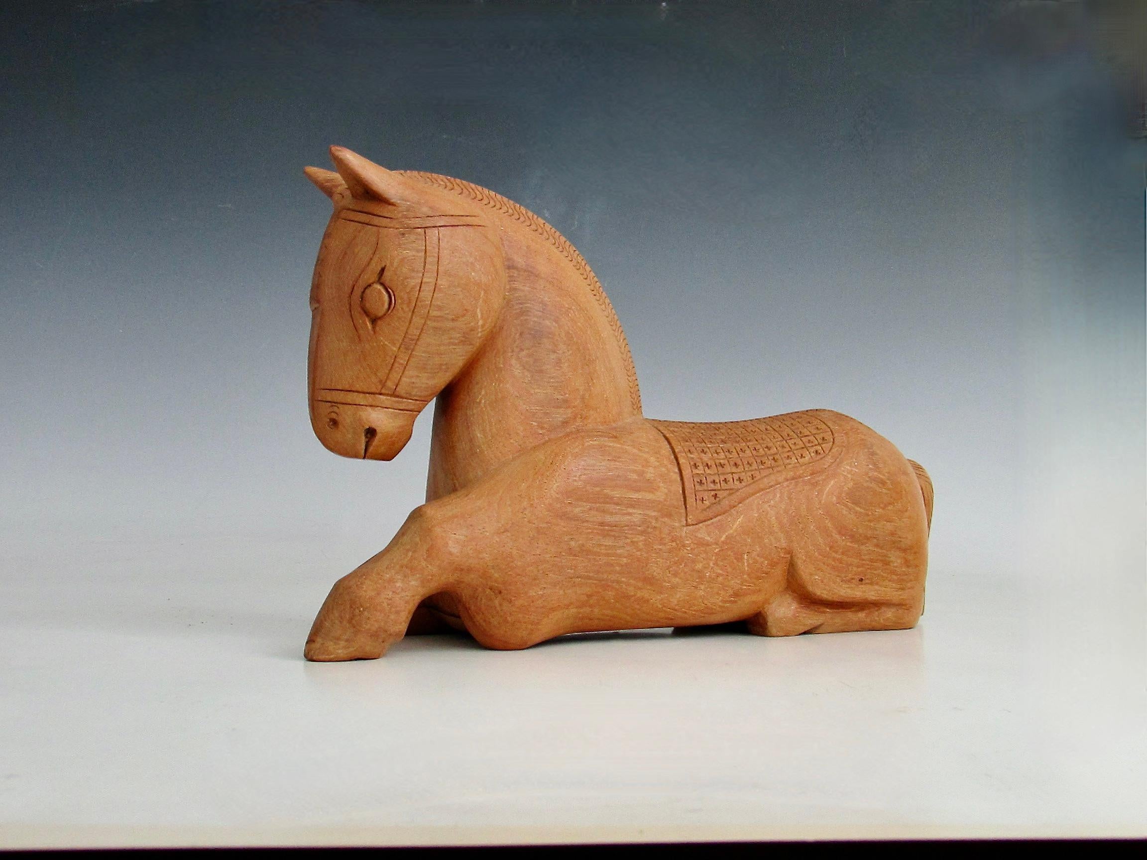 Nicely hand carved somewhat stylized figure of a horse . Hidden compartment on the underside . 